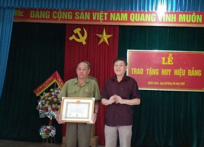 Trao huy hiệu 45 năm tuổi Đảng cho đảng viên Hà Đình Việt. Ảnh: Nguyễn Hường