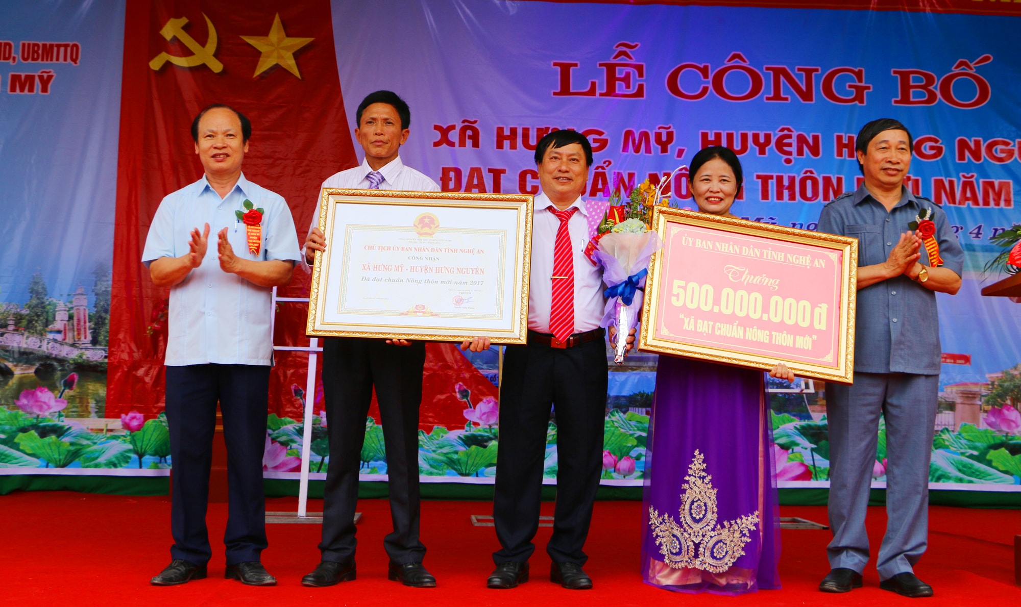 Đồng chí Nguyễn Văn Lập - Phó Giám đốc Sở Nông nghiệp & PTNT và đồng chí Hoàng Văn Phí - Tỉnh ủy viên, Bí thư Huyện ủy Hưng Nguyên trao Bằng công nhận và phần thưởng về đích NTM cho xã Hưng Mỹ. Ảnh: Nguyễn Hải