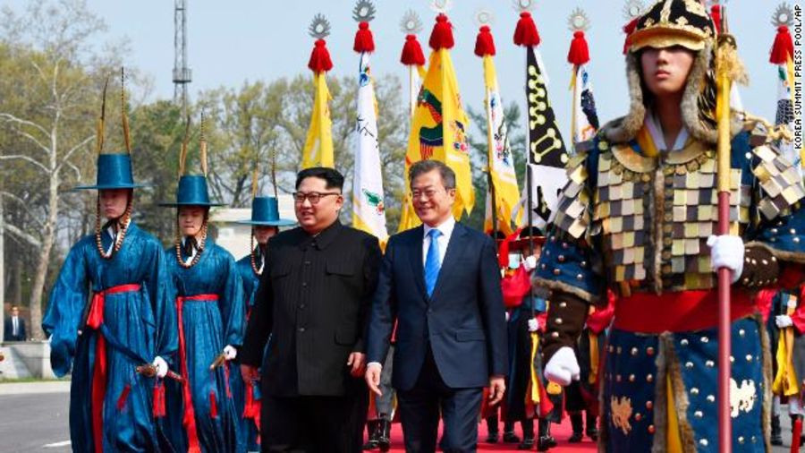 Nhà lãnh đạo Triều Tiên Kim Jong-un (trái) và Tổng thống Hàn Quốc Moon Jae-in sải bước sau khi băng qua phía Nam khu DMZ. Ảnh: AP