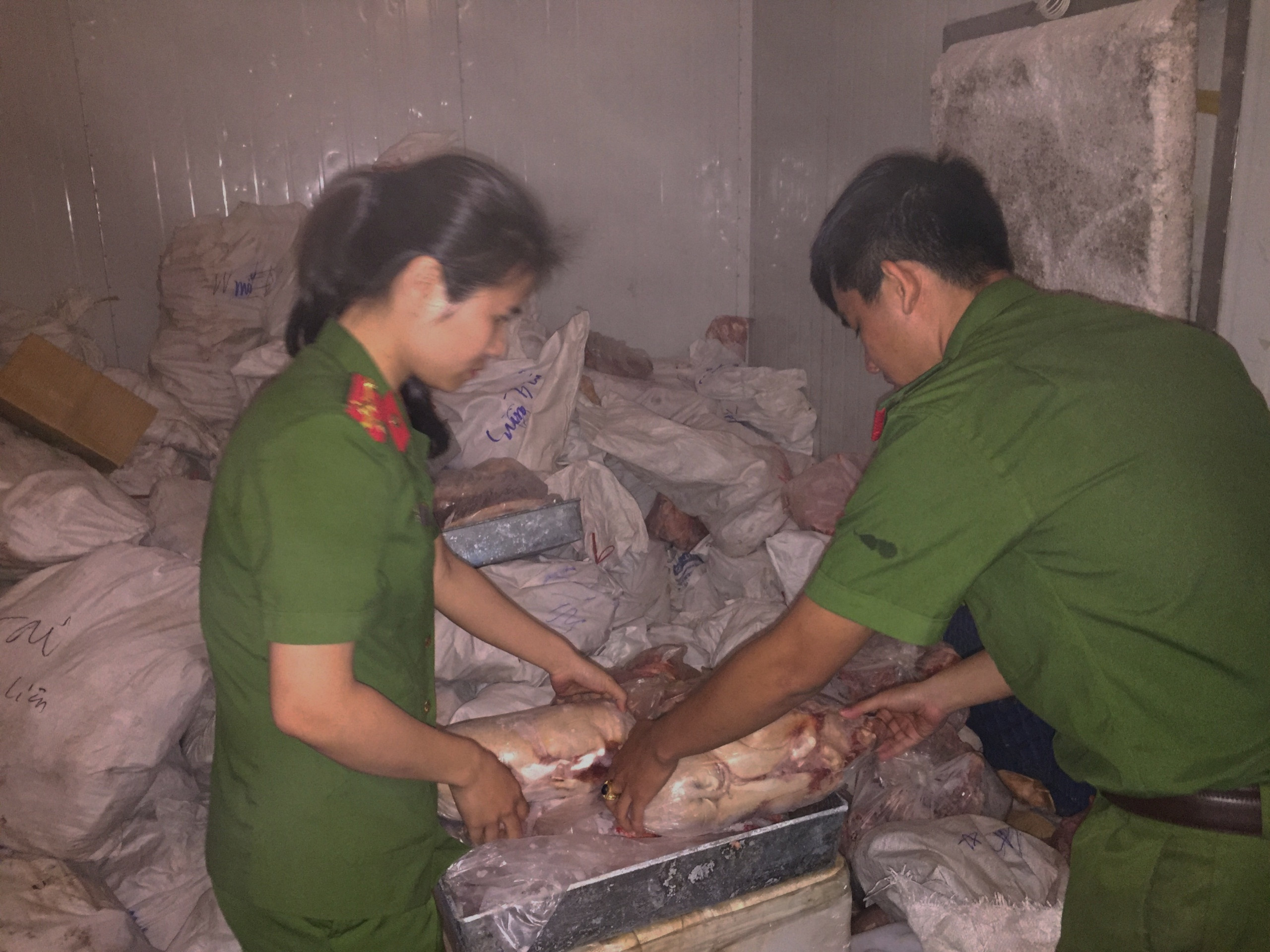 Cảnh sát Môi trường ( Công an thành phố Vinh) kiểm tra số thực phẩm không rõ nguồn gốc. Ảnh: Hồng Quang