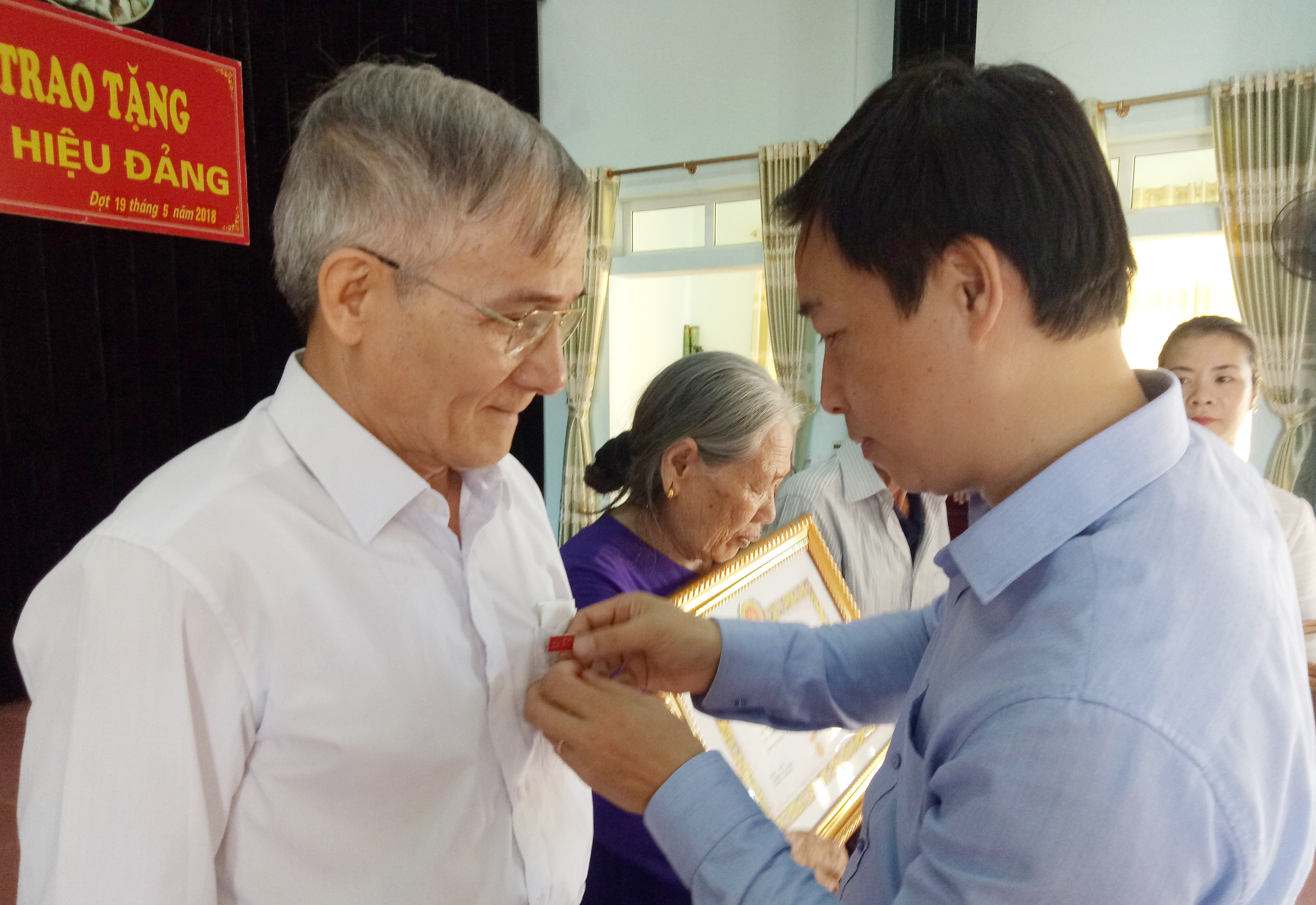 Lãnh đạo huyện ủy Nghĩa Đàn trao huy hiểu Đảng cho các đảng viên tại xã Tây Hiếu. Ảnh: Quang Huy.