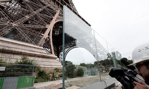 Hàng rào bằng kính dày 6,5 cm tạo thành hai mặt bảo vệ tháp Eiffel. Ảnh: Reuters.