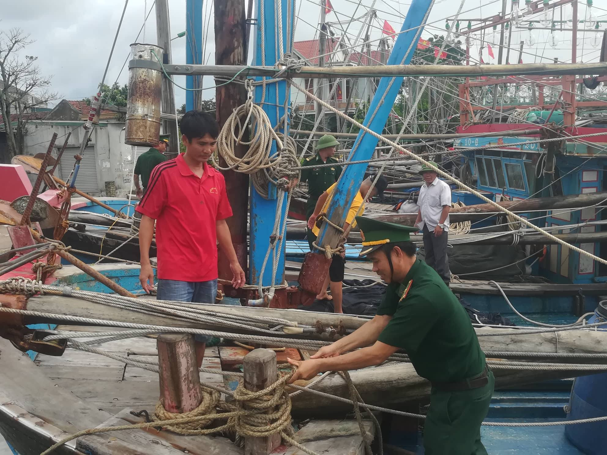 Cán bộ, chiến sỹ Đồn Biên phòng Quỳnh Thuận giúp ngư dân chằng chống tàu thuyền. Ảnh: Hải Thượng