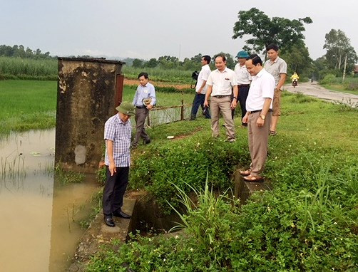 1 Đồng chí Hoàng Quốc Việt - Chủ tịch UBND huyện Tân Kỳ kiểm tra thân đập bị sạt lỡ tại xã Tân Hương. Ảnh: 