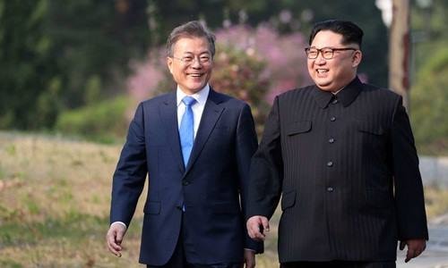 [Caption]Ảnh: Tổng thống Hàn Quốc Moon Jae-in (trái) và lãnh đạo Triều Tiên Kim Jong-un tại hội nghị thượng đỉnh ngày 26/4 ở Panmunjom. Ảnh: Korea Summit Press Pool.