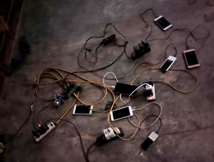 Người dân ở xã Quang Phong (Quế Phong) tập trung ở một gia đình có máy phát điện để sạc điện thoại. Ảnh: Hùng Cường