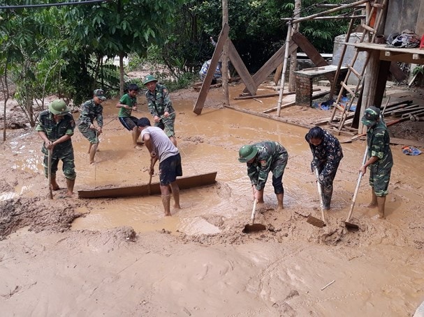 Cán bộ chiến sỹ Đồn BP Mường Típ giúp các hộ gia đình dọn dẹp vệ sinh sau lũ. Ảnh: Hải Thượng