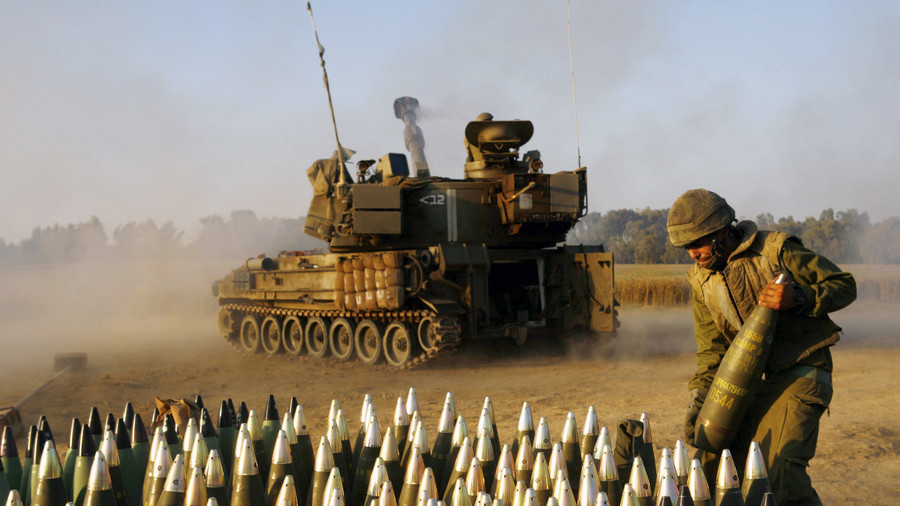 Một binh sỹ Israel đứng cạnh khẩu đội pháo di động. Ảnh: AP