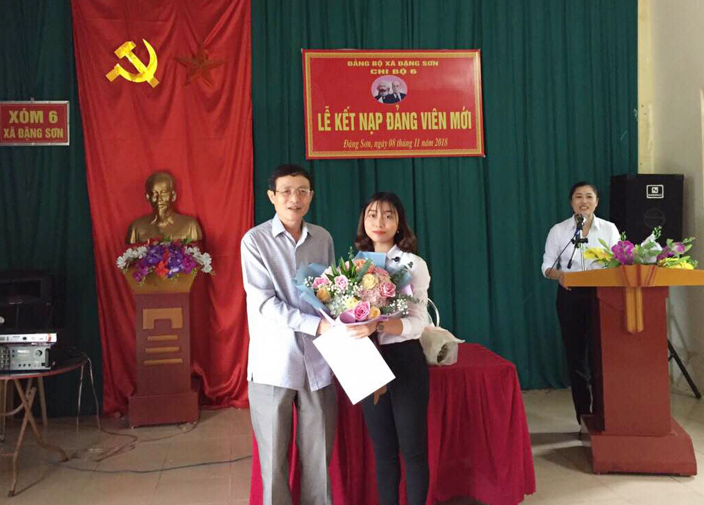 Phó Bí thư phụ trách Đảng ủy Khối các cơ quan tỉnh Hoàng Văn Nhiên tặng hoa chúc mừng đảng viên mới Trần Thị Ngọc Anh. Ảnh Lê Thanh