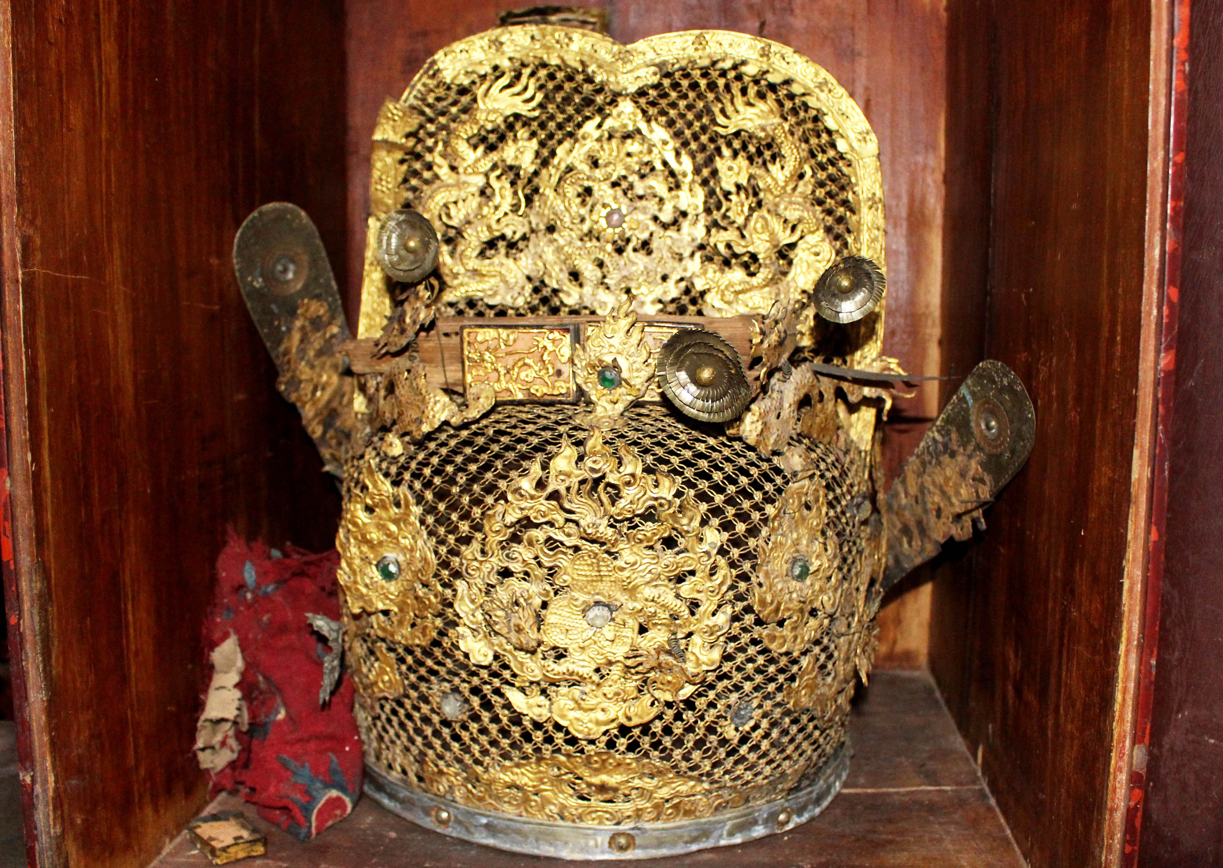 Một chiếc mũ thờ làm bằng kim loại, trải qua hàng trăm năm vẫn rực sáng màu đồng. Ảnh: Huy Thư.