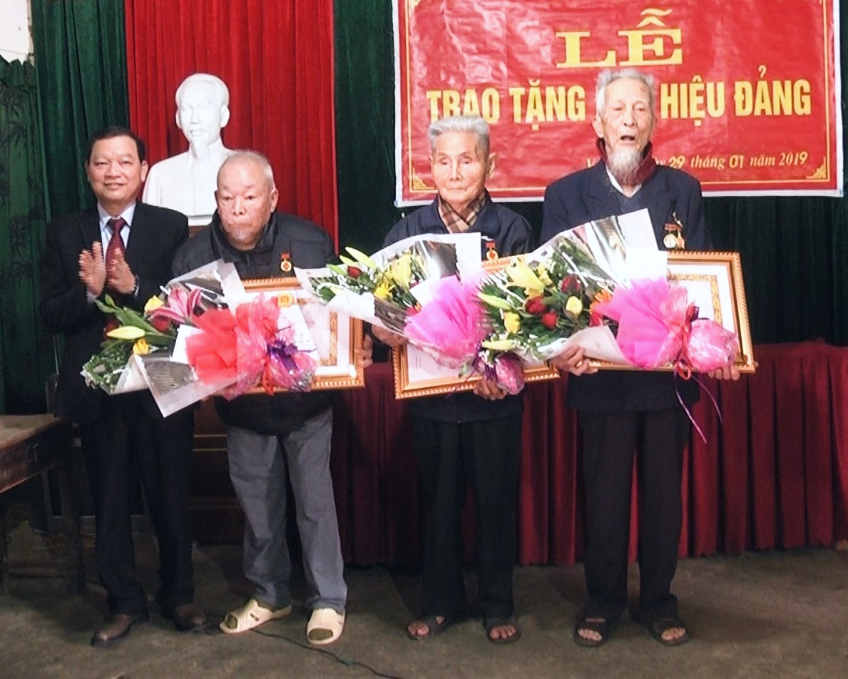 Bí thư Huyện ủy Thanh Chương Nguyễn Hữu Vinh trao Huy hiệu 70 tuổi Đảng cho các đảng viên. Ảnh: Đình Hà 