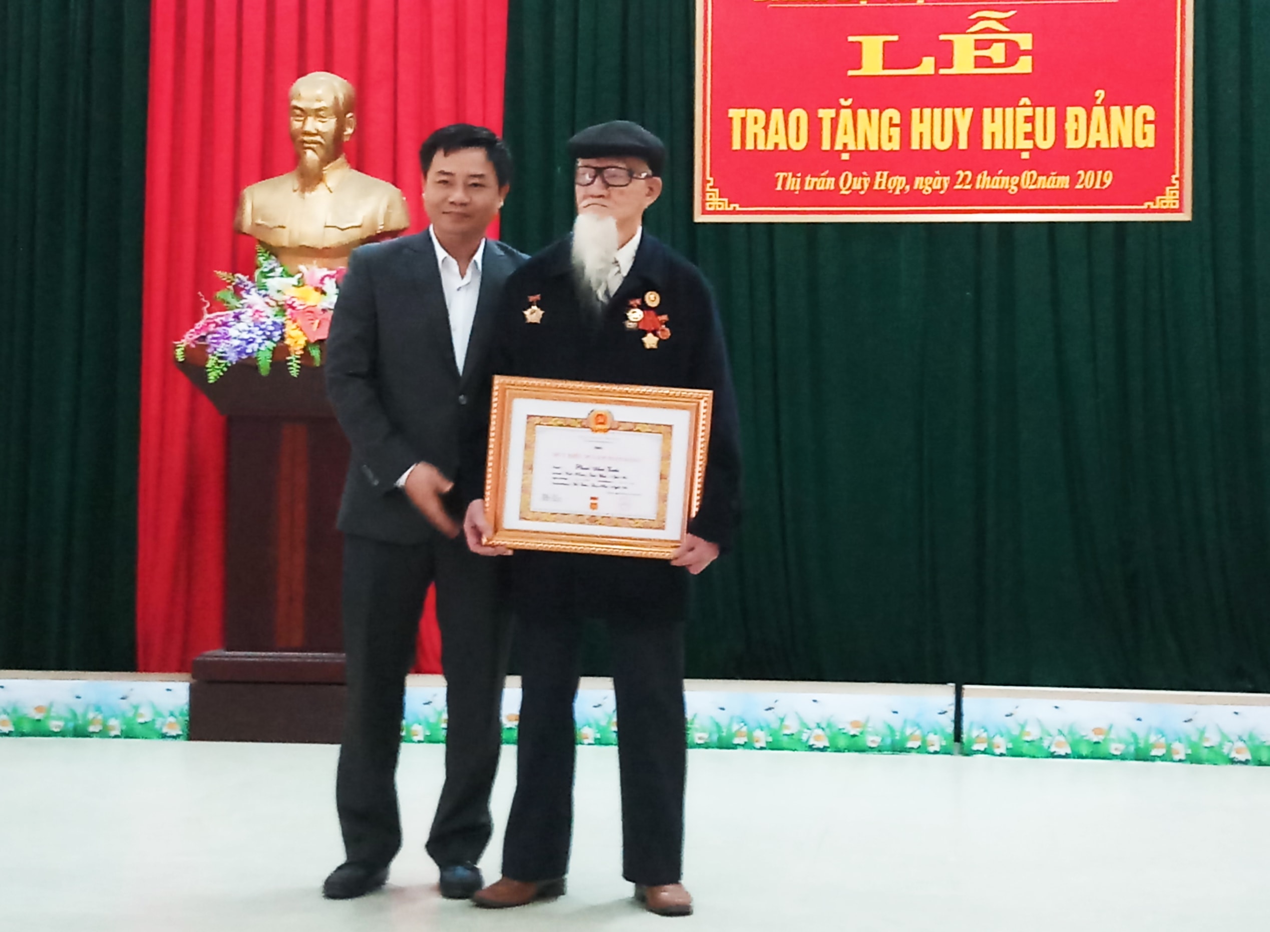 Bí thư Huyện ủy Quỳ Hợp Hồ Lê Ngọc  trao Huy hiệu 70 tuổi Đảng cho Đảng viên. Ảnh: Thanh Hợp 