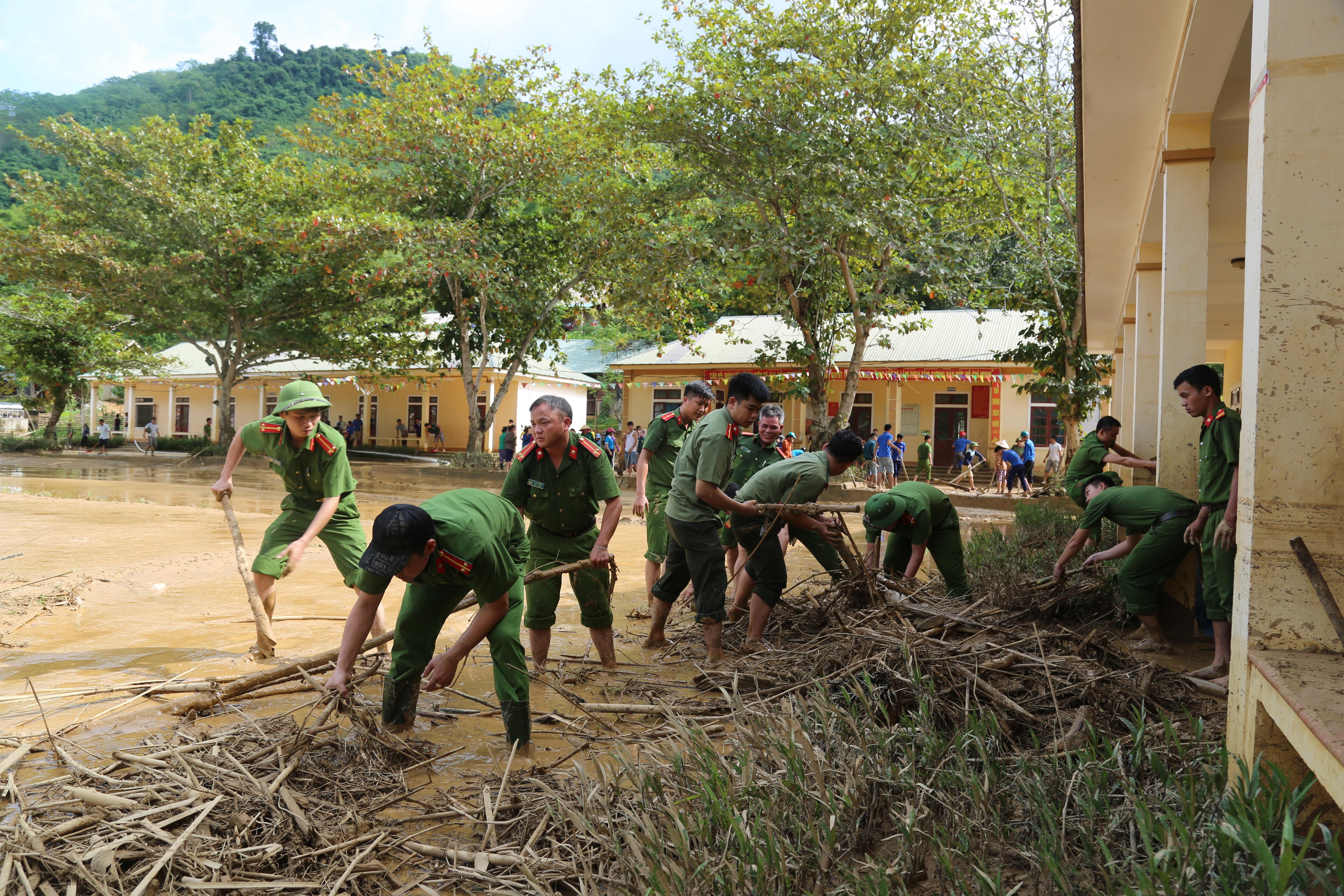 Đoàn viên thanh niên Công an huyện Tương Dương cùng với người dân dọn dẹp trường THCS Yên Tĩnh sau trận lũ quét vào tháng 9/2018. Ảnh: CTV