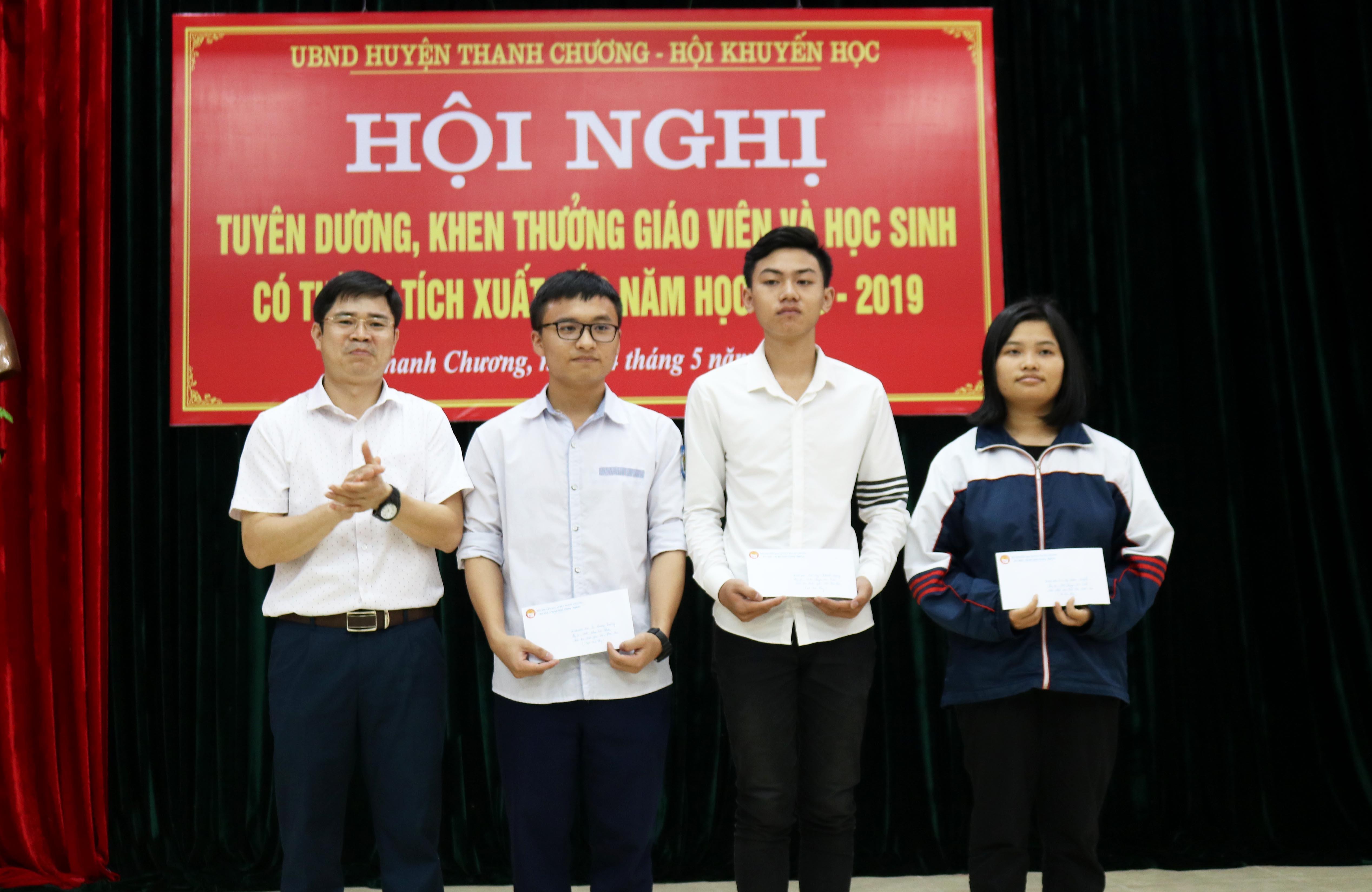 Đồng chí Trình Văn Nhã - Phó Bí thư Huyện ủy, Chủ thịch Hội khuyến học huyện trao thưởng cho các học sinh đạt giải Quốc gia