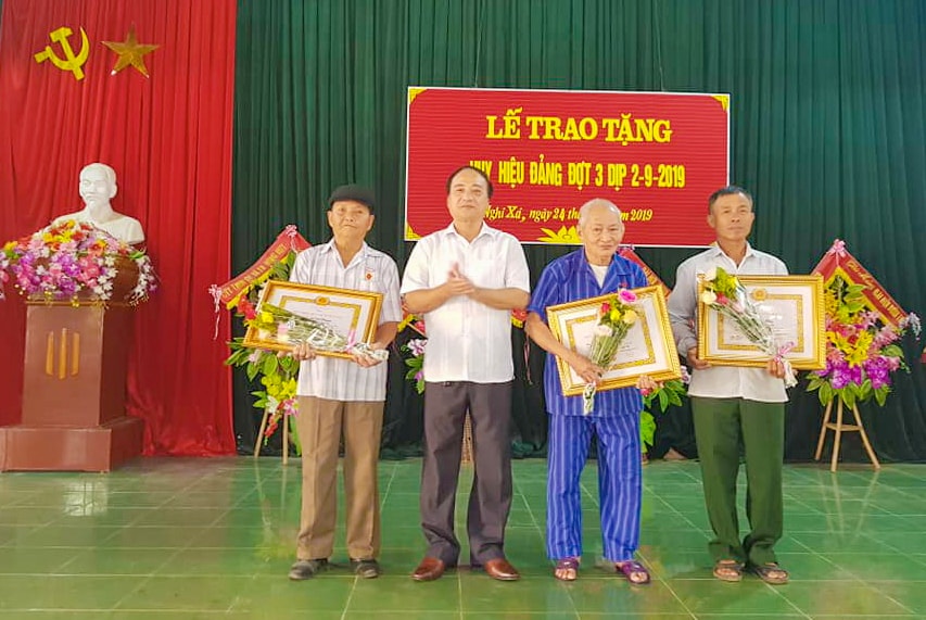  Đồng chí Lê Văn Dũng, Phó Bí thư Huyện ủy Nghi Lộc trao Huy hiệu Đảng cho các đảng viên