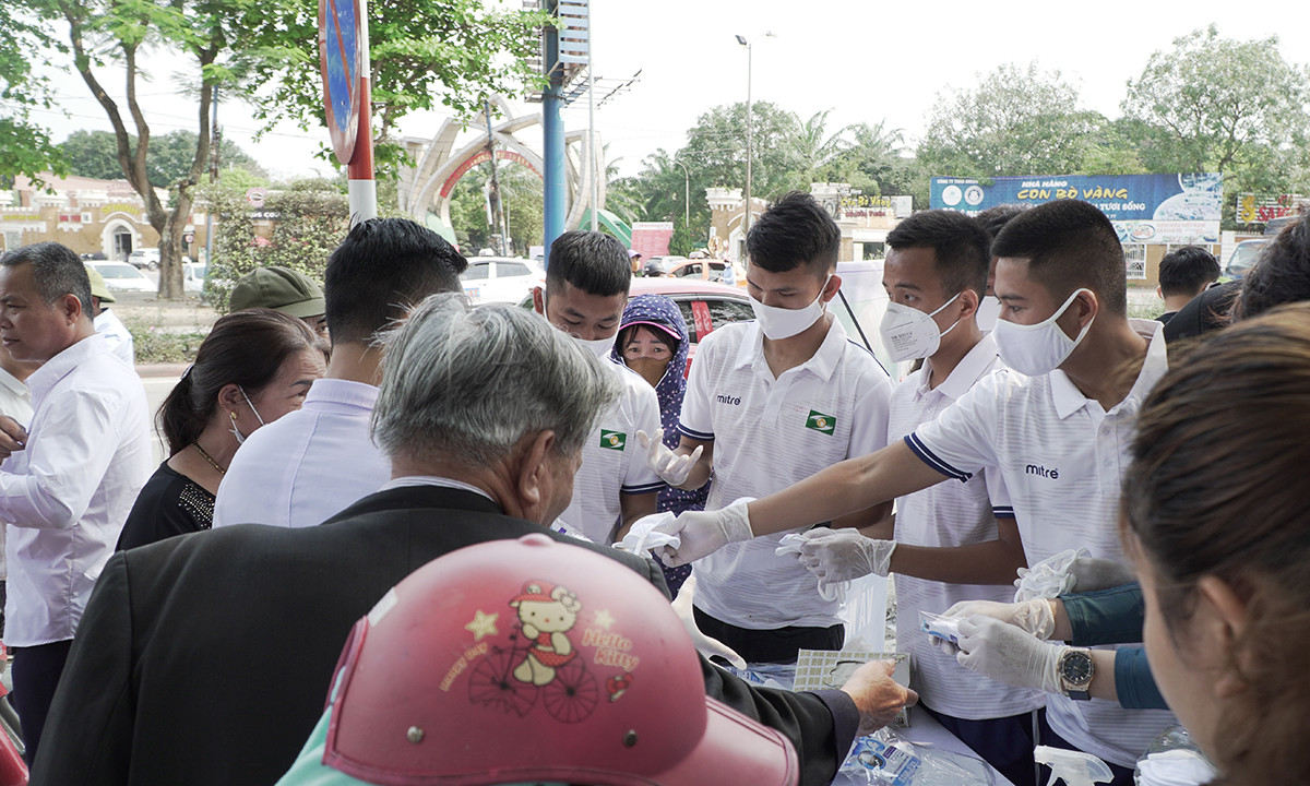 Trong buổi sáng, các cầu thủ SLNA đã xuống đường phát khẩu trang miễn phí cho người dân thành phố Vinh. Ảnh: Trung Kiên