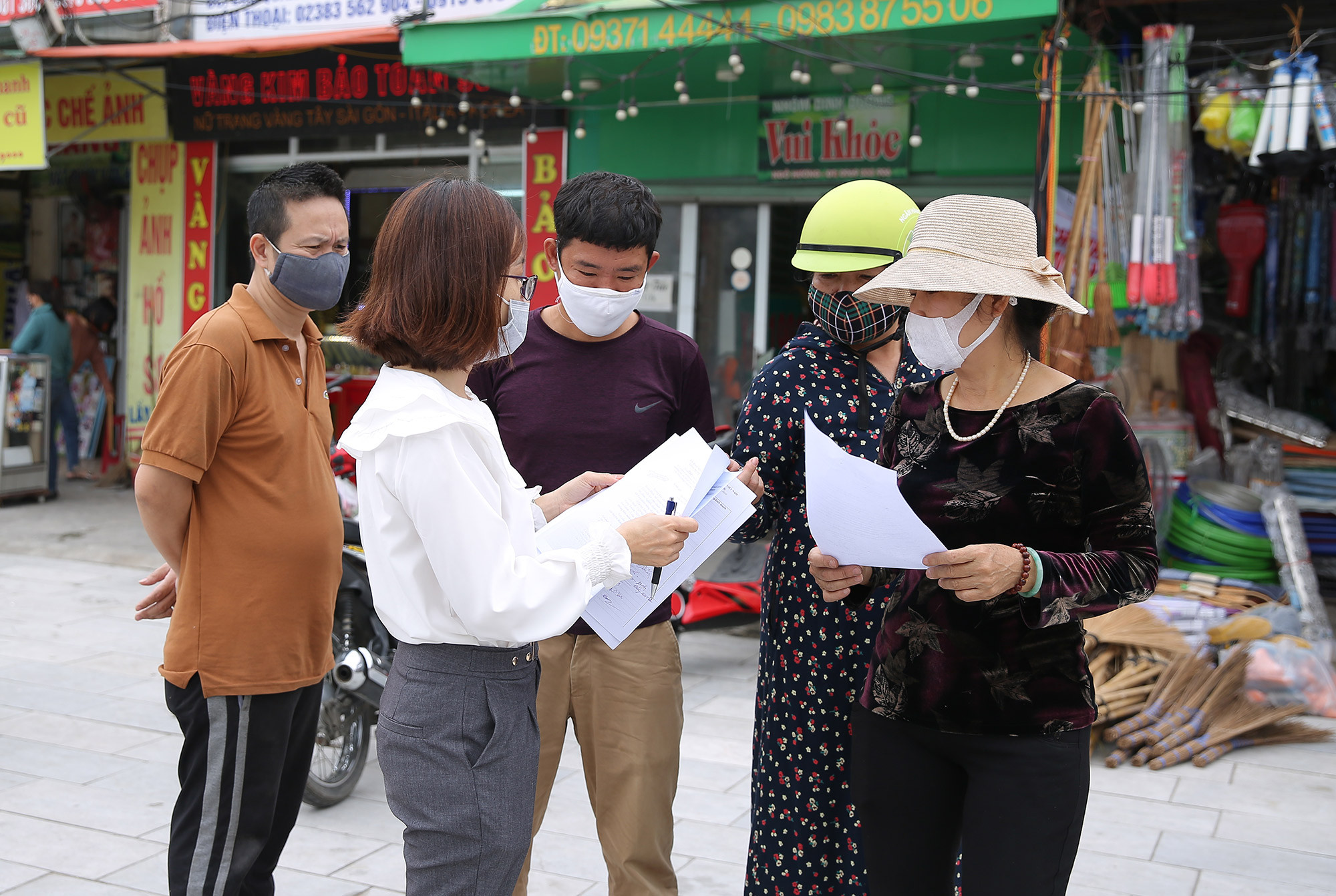 BQL chợ Quán Lau tuyên truyền các hộ kinh doanh tiếp tục thực hiện cách ly xã hội theo tinh thần chỉ đạo của Thủ tướng Chính phủ và UBND tỉnh Nghệ An. Ảnh: Lâm Tùng