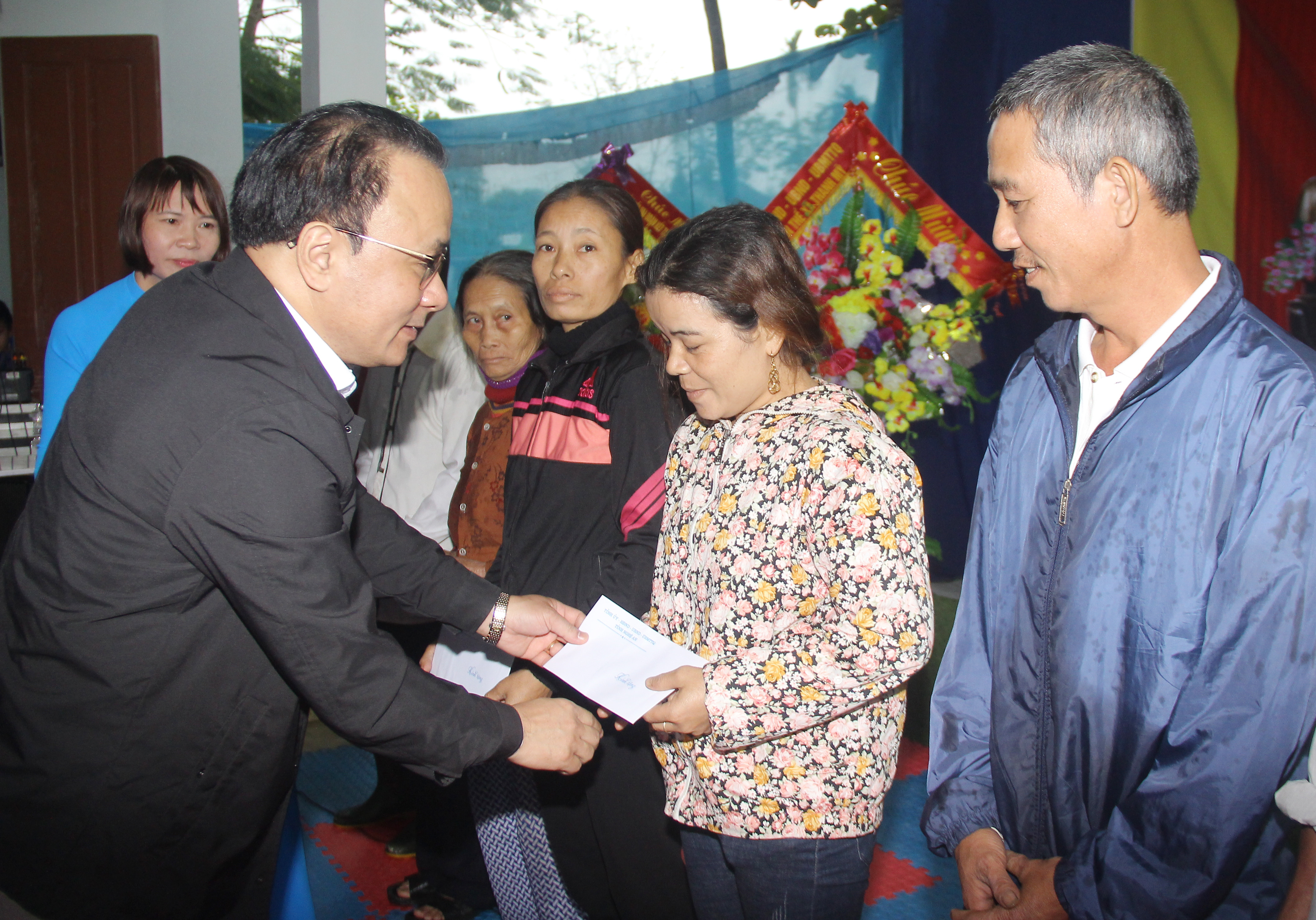 Đồng chí Nguyễn Nam Đình - Ủy viên Ban Thường vụ Tỉnh ủy, Bí thư Đảng ủy Khối các cơ quan tỉnh tặng quà cho các hộ nghhèo. Ảnh: Mai Hoa