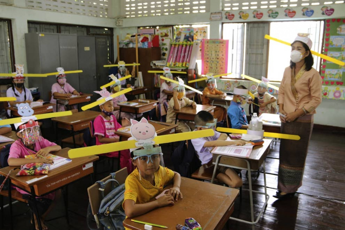 Giáo viên và học sinh đeo khẩu trang và mặt nạ chống giọt bắn để phòng dịch Covid-19, tại trường Ban Pa Muad ở Chiang Mai, Thái Lan. Ảnh: AP 