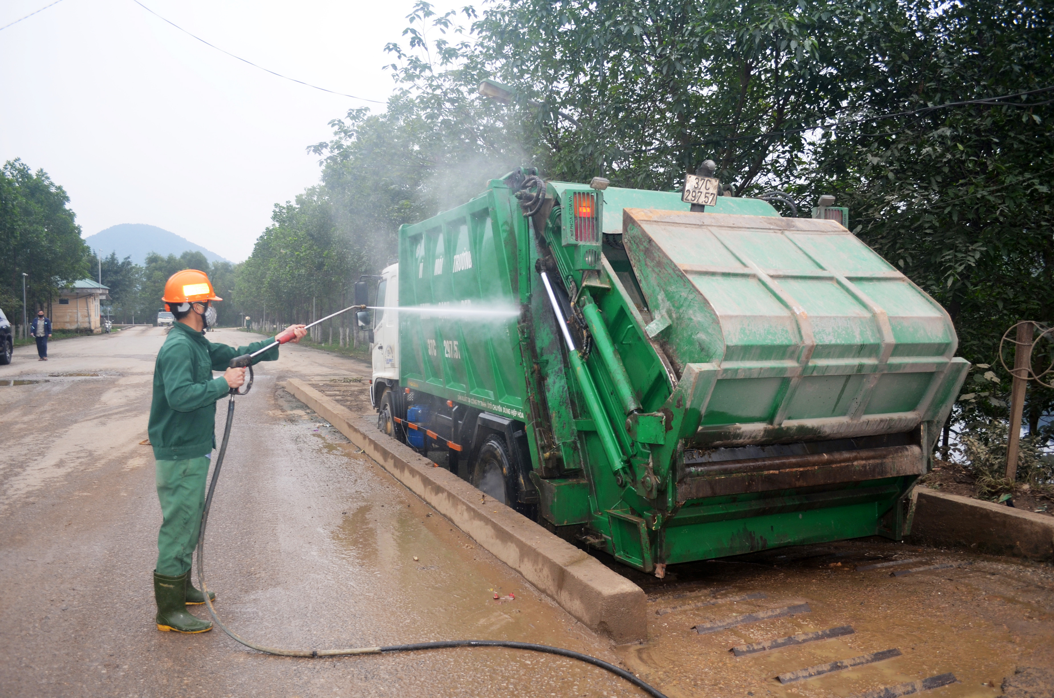 Vệ sinh phương tiện vận chuyển rác tại Khu liên hợp xử lý chất thải Nghi Yên (Nghi Lộc). Ảnh: Nhật Lân
