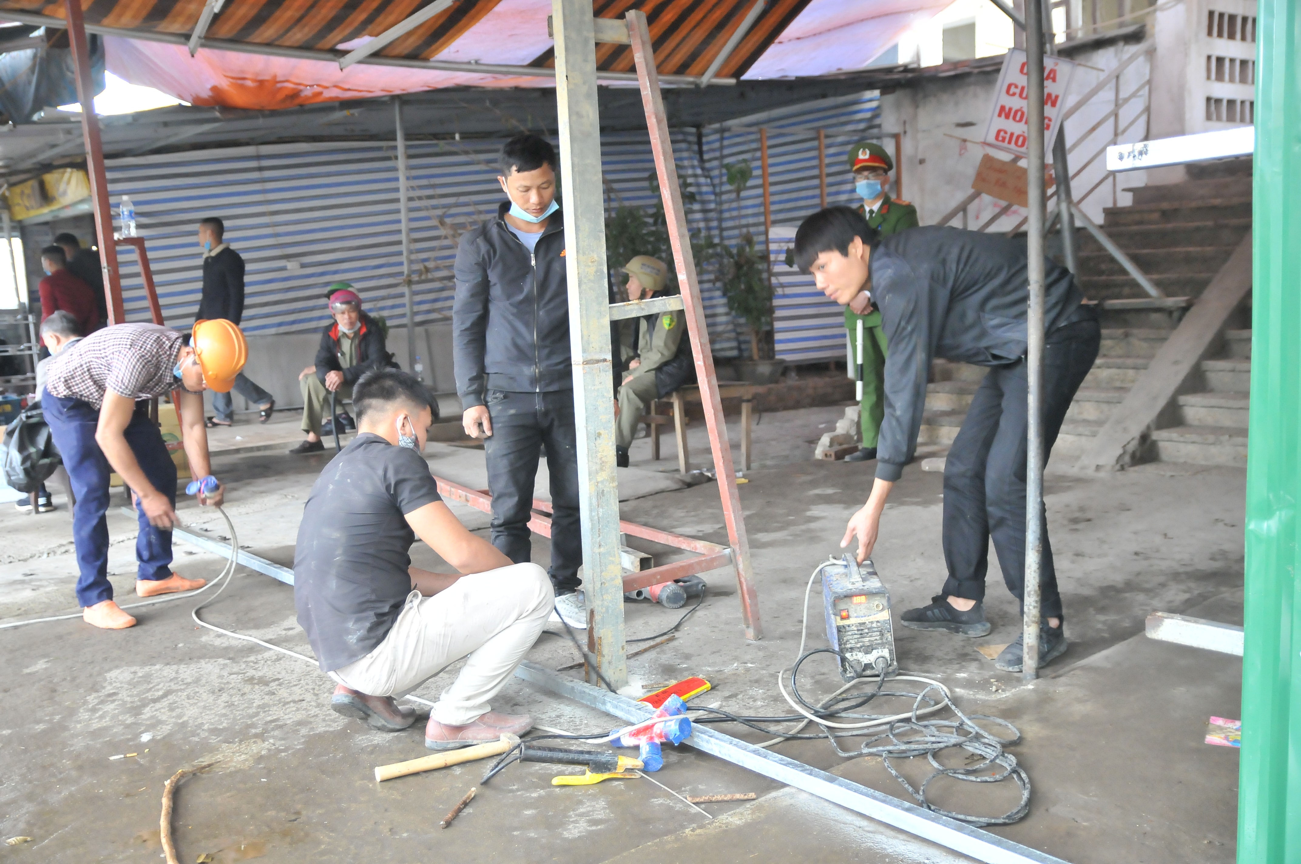 Lực lượng chức năng tiến hành phá dỡ cột chống, lều bạt trước các tòa nhà chung cư B3 và B6