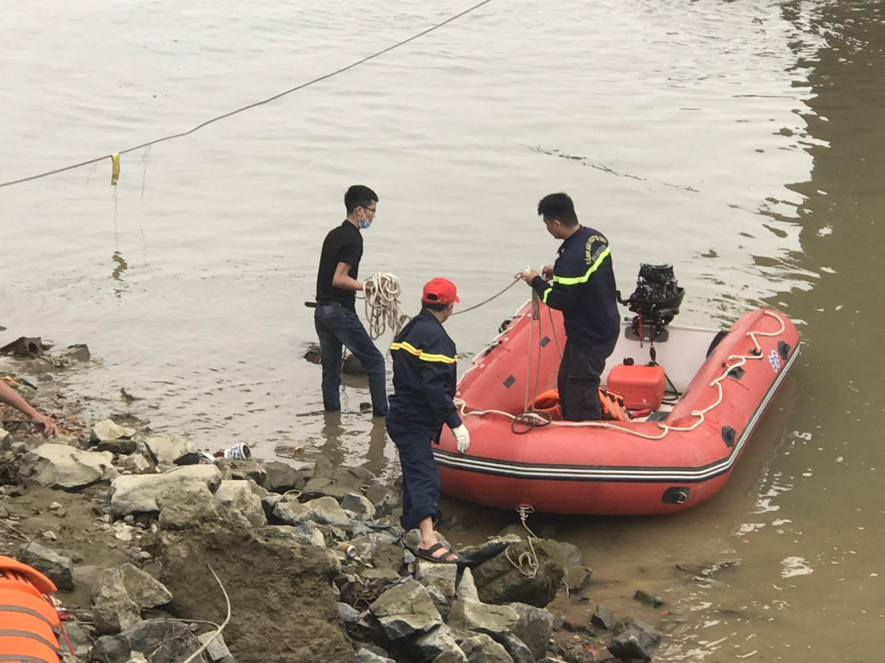 Lực lượng cứu hộ đưa thi thể anh D. vào bờ. Ảnh: Chu Minh
