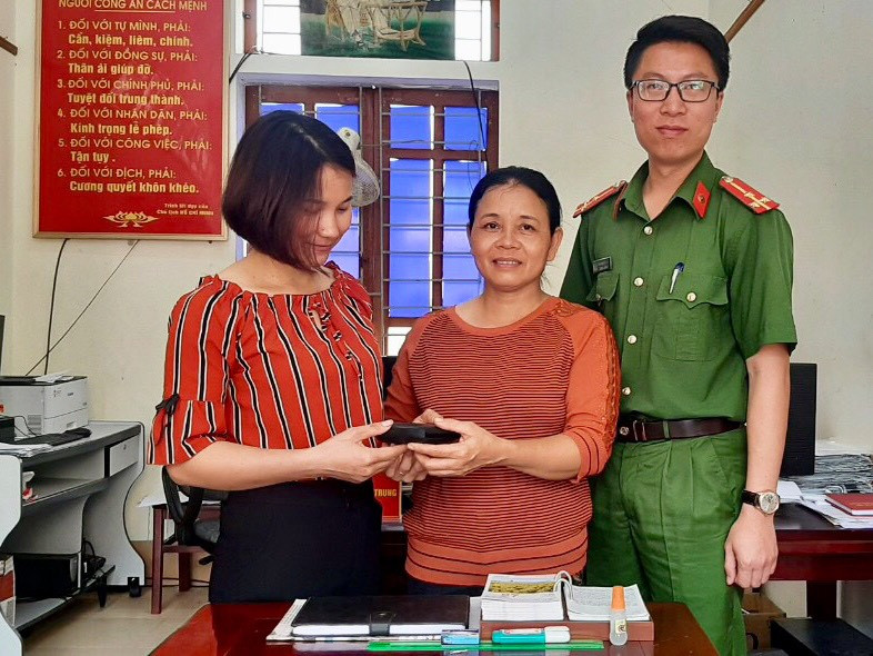  Chị Hồ Thị Hiền (đứng giữa) trao trả lại chiếc ví cho gia đình người đánh mất. Ảnh: Ngọc Phương