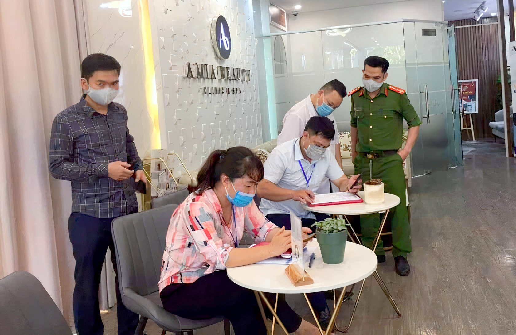 Đoàn công tác phường Hưng Bình lập biên bản đối với spa vi phạm. Ảnh: Q.A