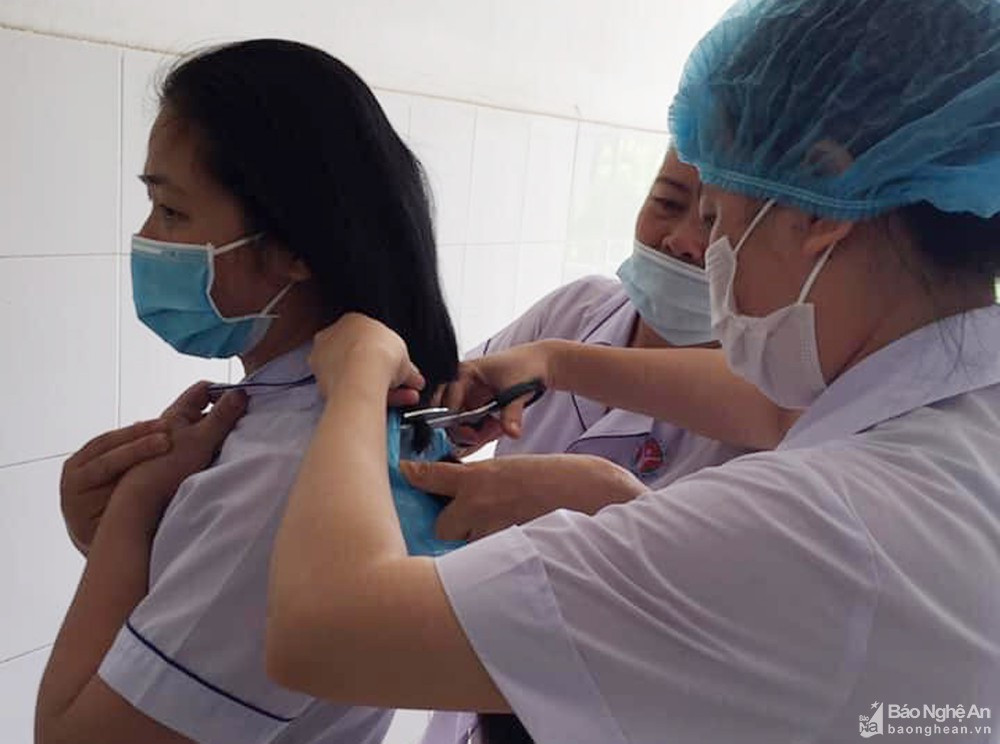 Nữ cán bộ y tế Hưng Nguyên hy sinh mái tóc chuẩn bị tham gia bệnh viện dã chiến. Ảnh: TTYTHN