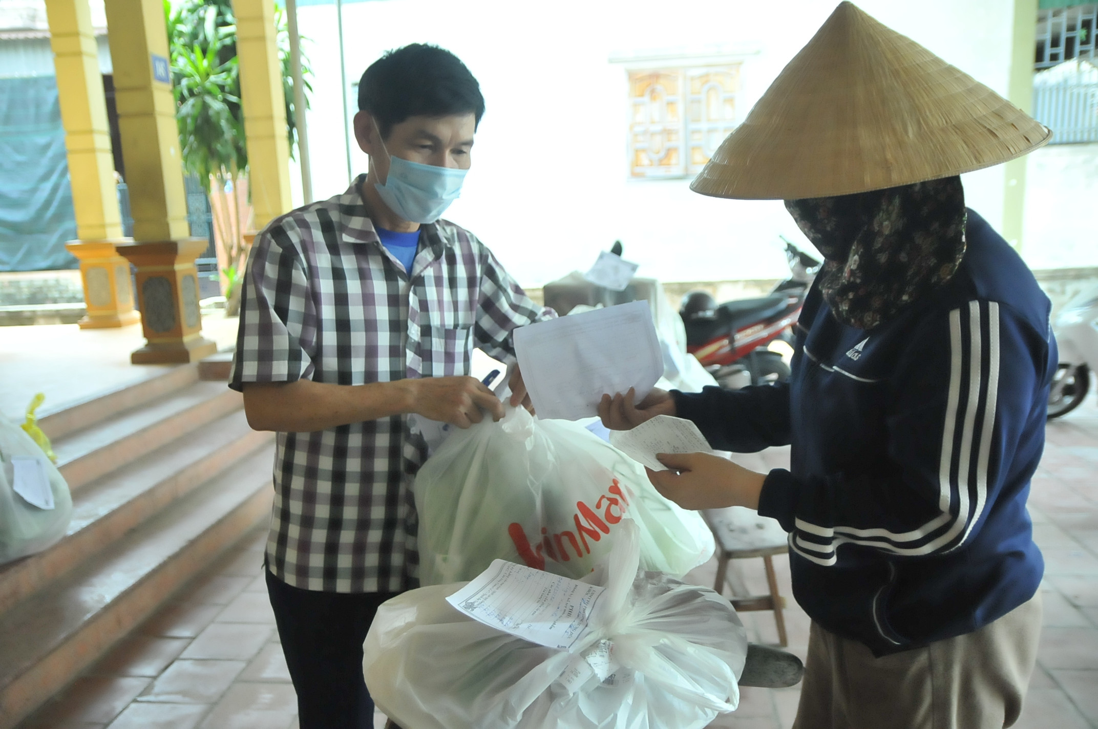 Các thành viên trong Ban mặt trận khối Tân Lâm (Hưng Dũng), kiểm tra lại hàng hóa trước khi mang đến cho các hộ dân. Ảnh: Tiến Đông