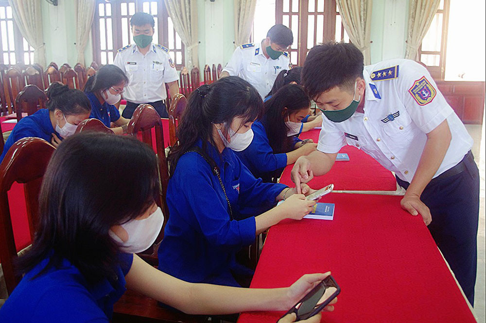 Chiến sĩ Cảnh sát biển hướng dẫn các bạn ĐVTN thi tìm hiểu Luật Cảnh sát biển Việt Nam. Ảnh: PV