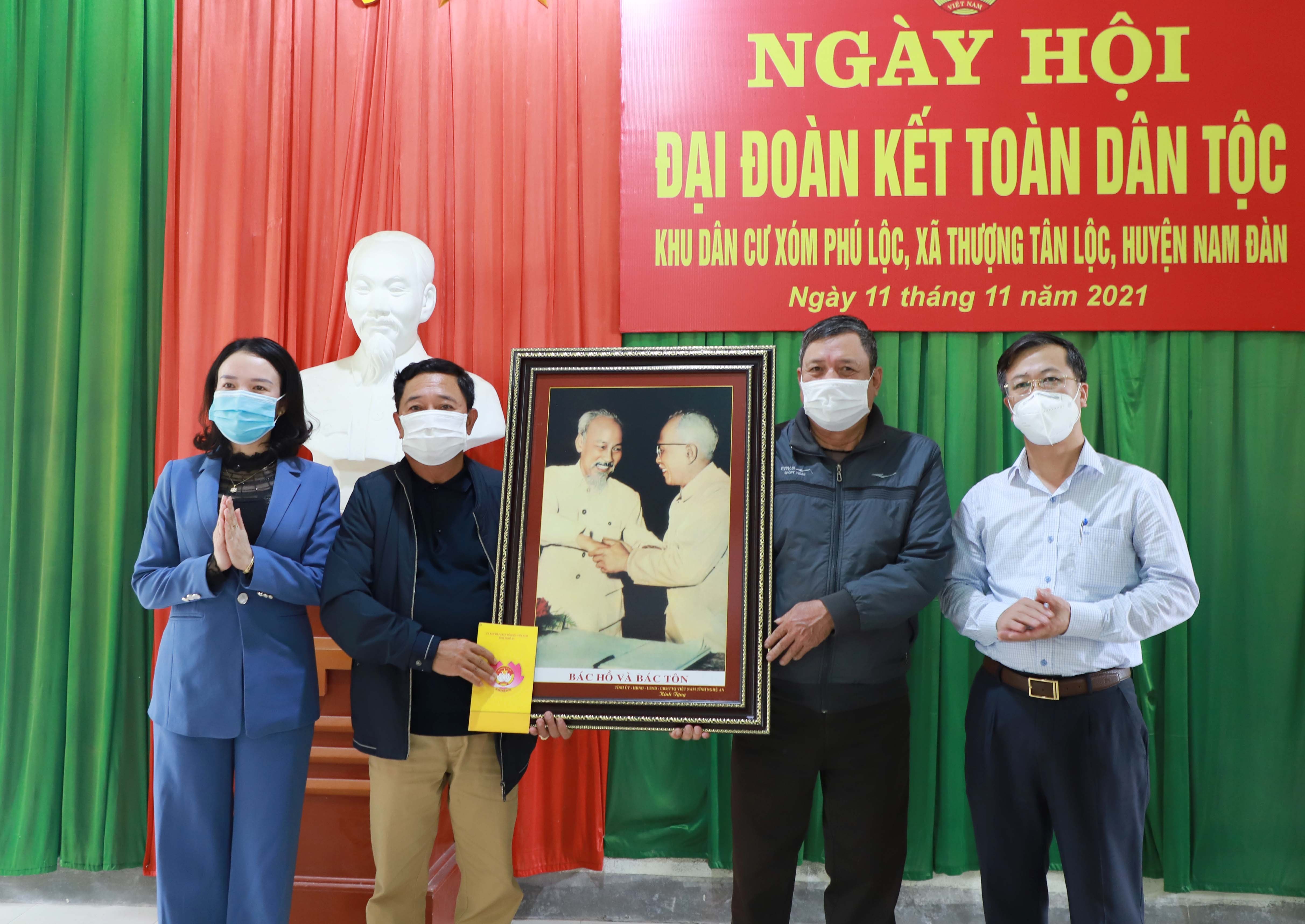 Đoàn công tác tặng quà cho Ban công tác Mặt trận xóm Phú Lộc. Ảnh: Phạm Bằng