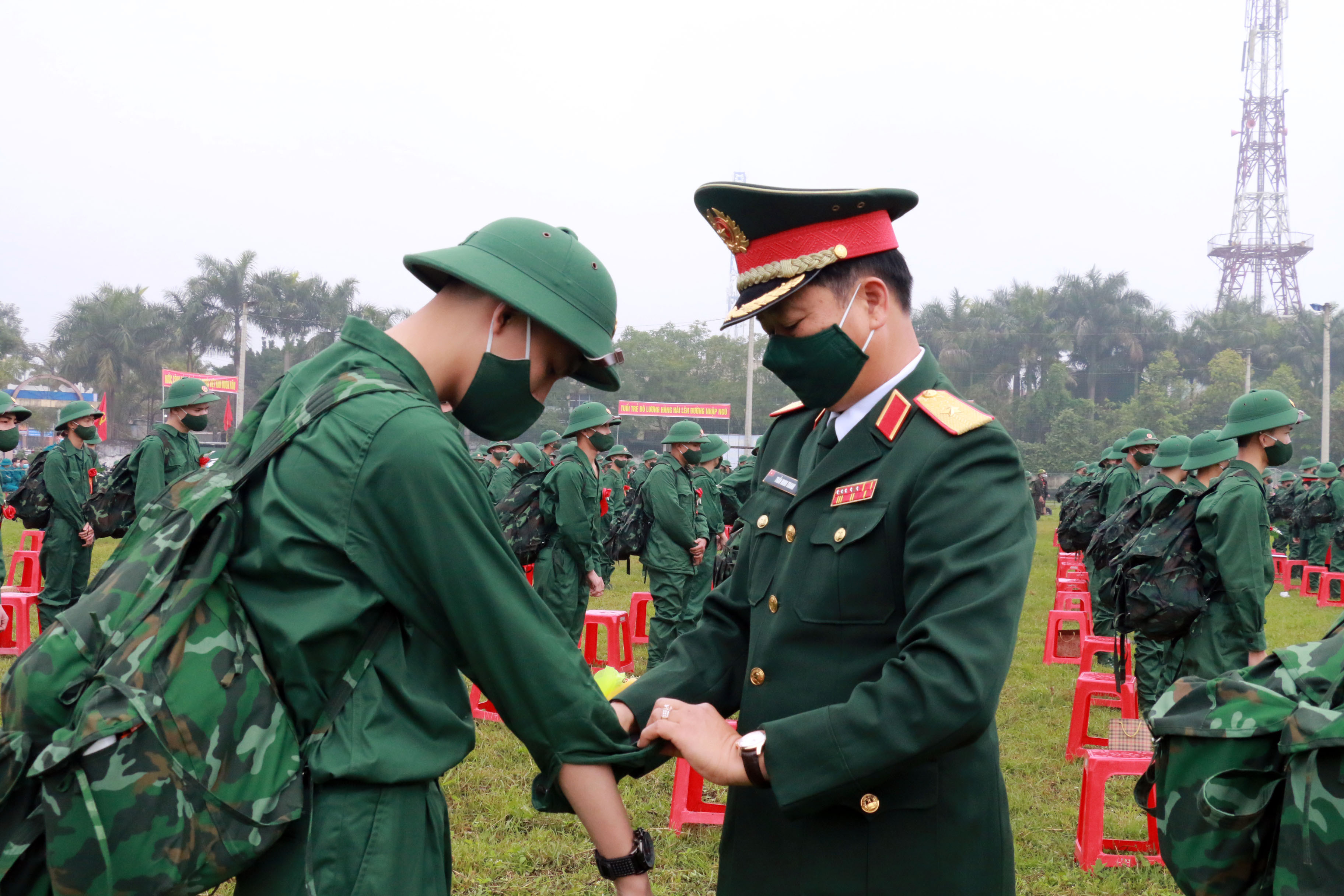 Đồng chí Thiếu tướng Trần Minh Thanh - Chủ nhiệm Chính trị Quân khu 4 gặp gỡ và trò chuyện, hướng dẫn các tân binh chỉnh trang quân phục trước khi nhập ngũ. Ảnh: MH