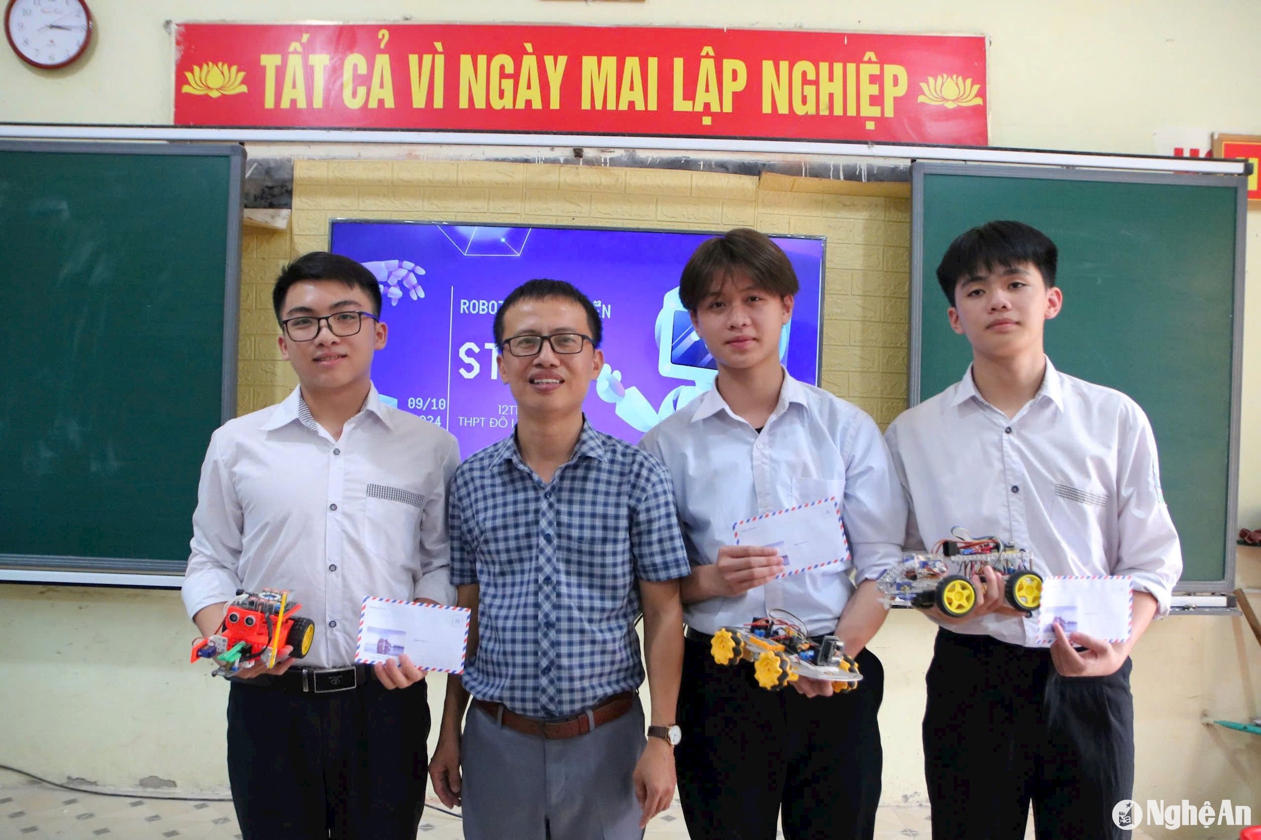 Thầy giáo Nguyễn Văn Tiến khen thưởng các học sinh đạt thành tích cao trong học tập. Ảnh - Mỹ Hà