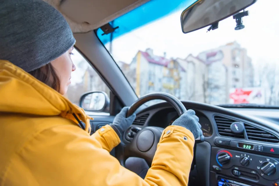 woman drive car cold winter.webp