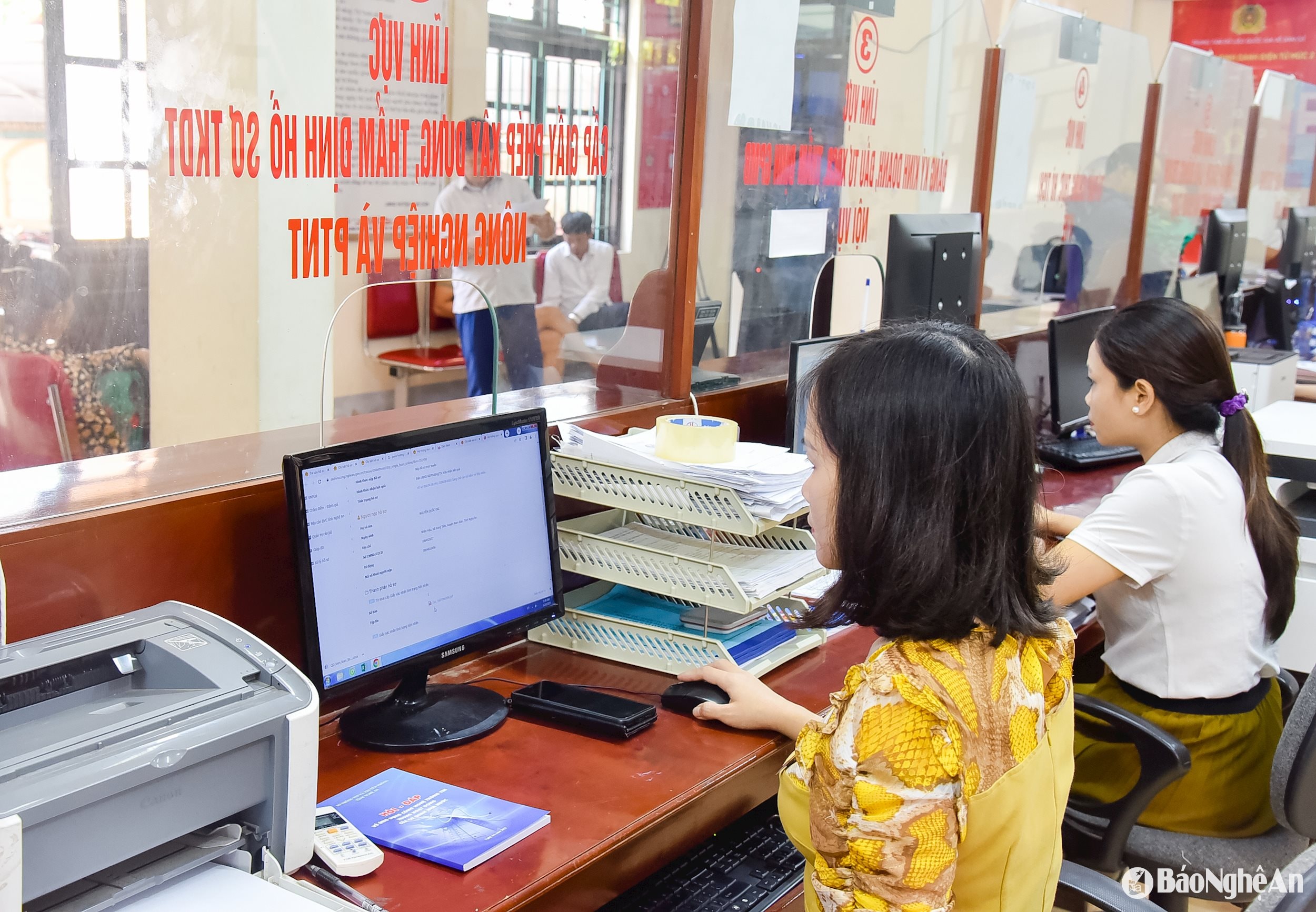 Giải quyết thủ tục hành chính cho người dân tại Bộ phận Một cửa UBND huyện Nam Đàn. Ảnh: TL