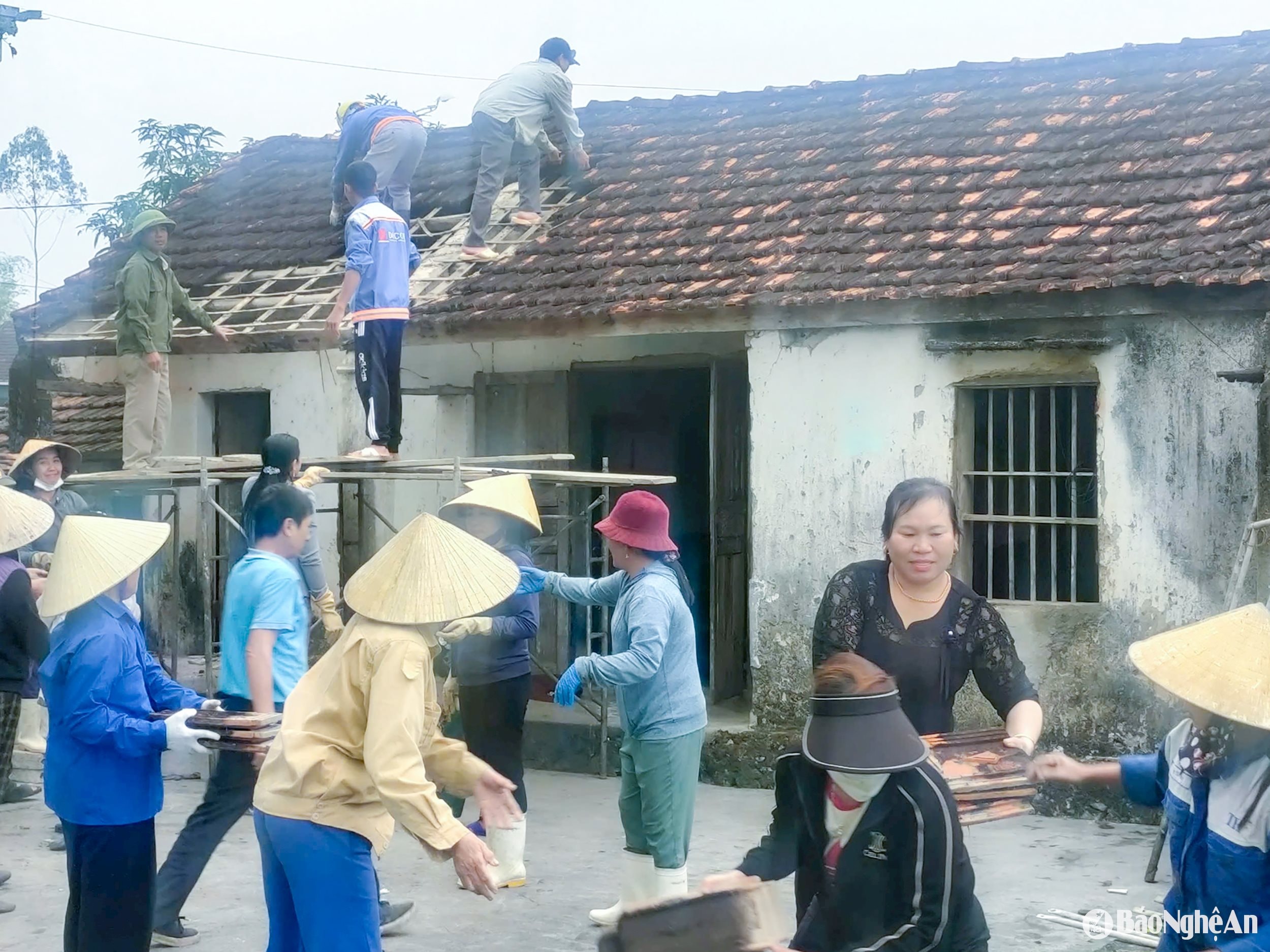 Các lực lượng trong hệ thống chính trị và người dân xã Lăng Thành (huyện Yên Thành) hỗ trợ người dân phá dỡ nhà cũ