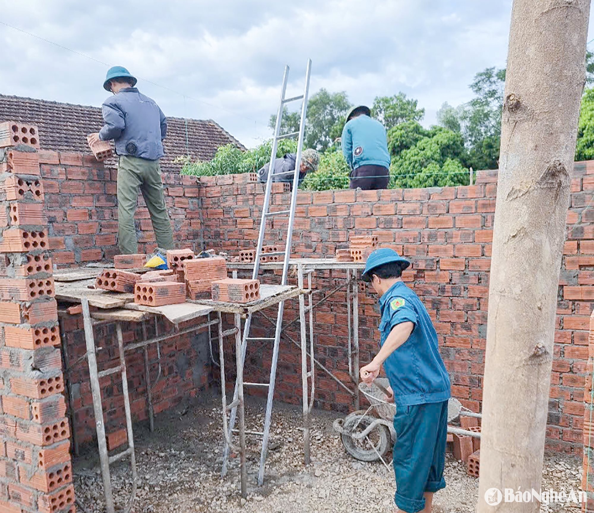 Lực lượng dân quân tự vệ xã Đồng Thành (huyện Yên Thành) giúp hộ nghèo làm nhà ở. Ảnh: Mai Hoa