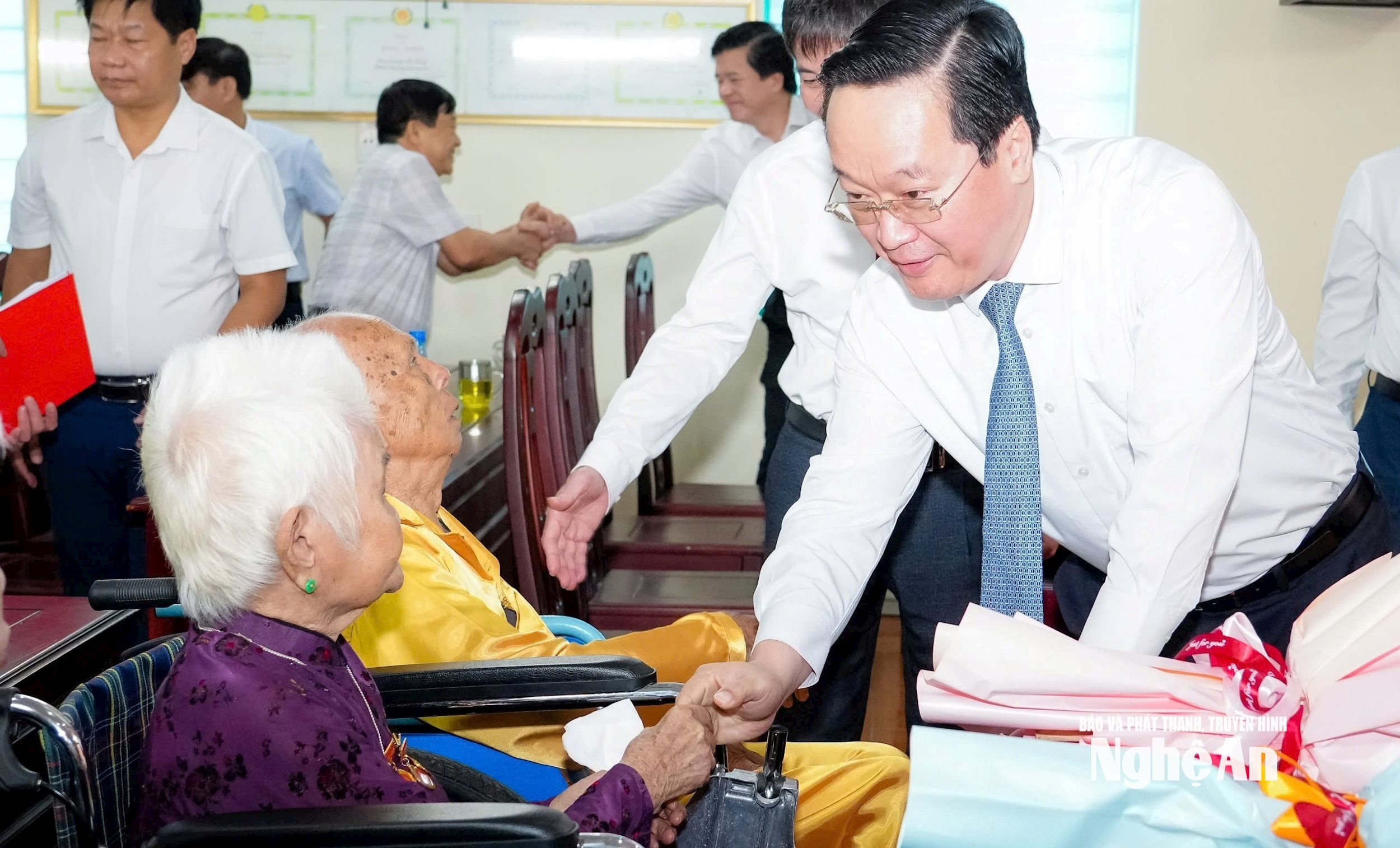 Bí thư Tỉnh uỷ Nguyễn Đức Trung hỏi thăm đảng viên lão thành Nguyễn Thị Đại. Ảnh tư liệu Phạm Bằng