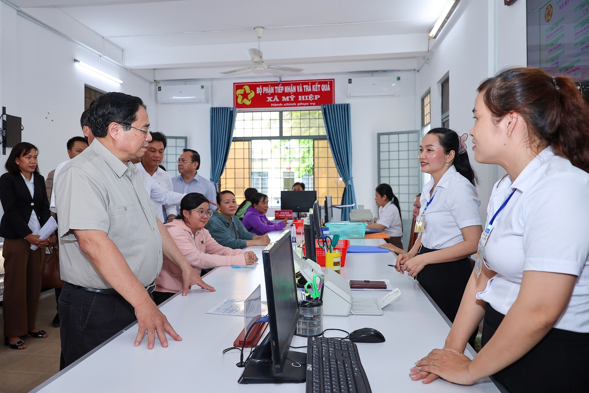 Thủ tướng Phạm Minh Chính trò chuyện với người dân và đội ngũ công chức xã tại Bộ phận tiếp nhận và trả kết quả xã Mỹ Hiệp, tỉnh Đồng Tháp - Ảnh VGP