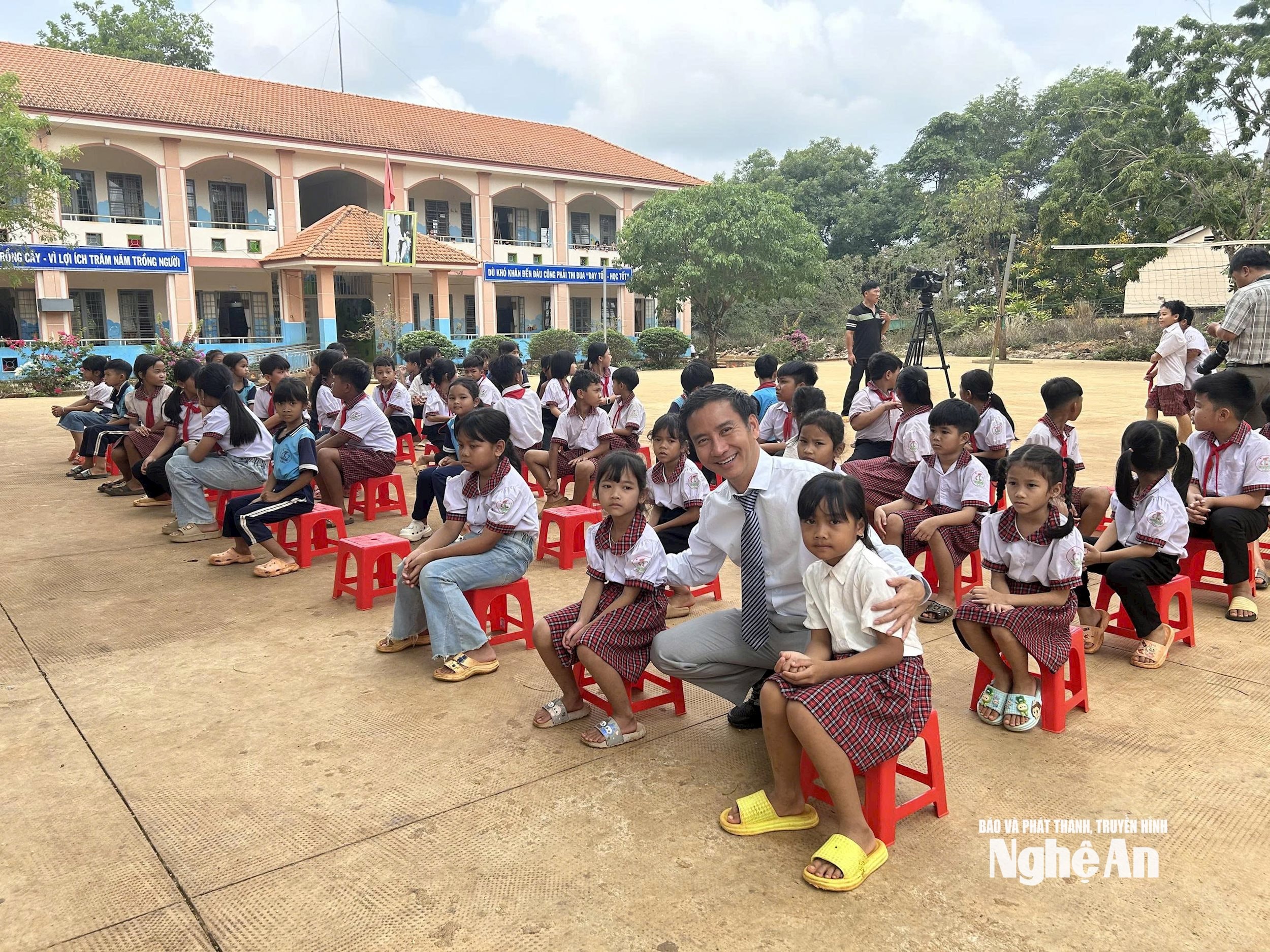 Anh Nguyễn Anh Tuấn cùng các em học sinh trong lễ trao tặng sách cho Trường tiểu học Bù Gia Mập, xã Bù Gia Mập, tỉnh Đồng Nai