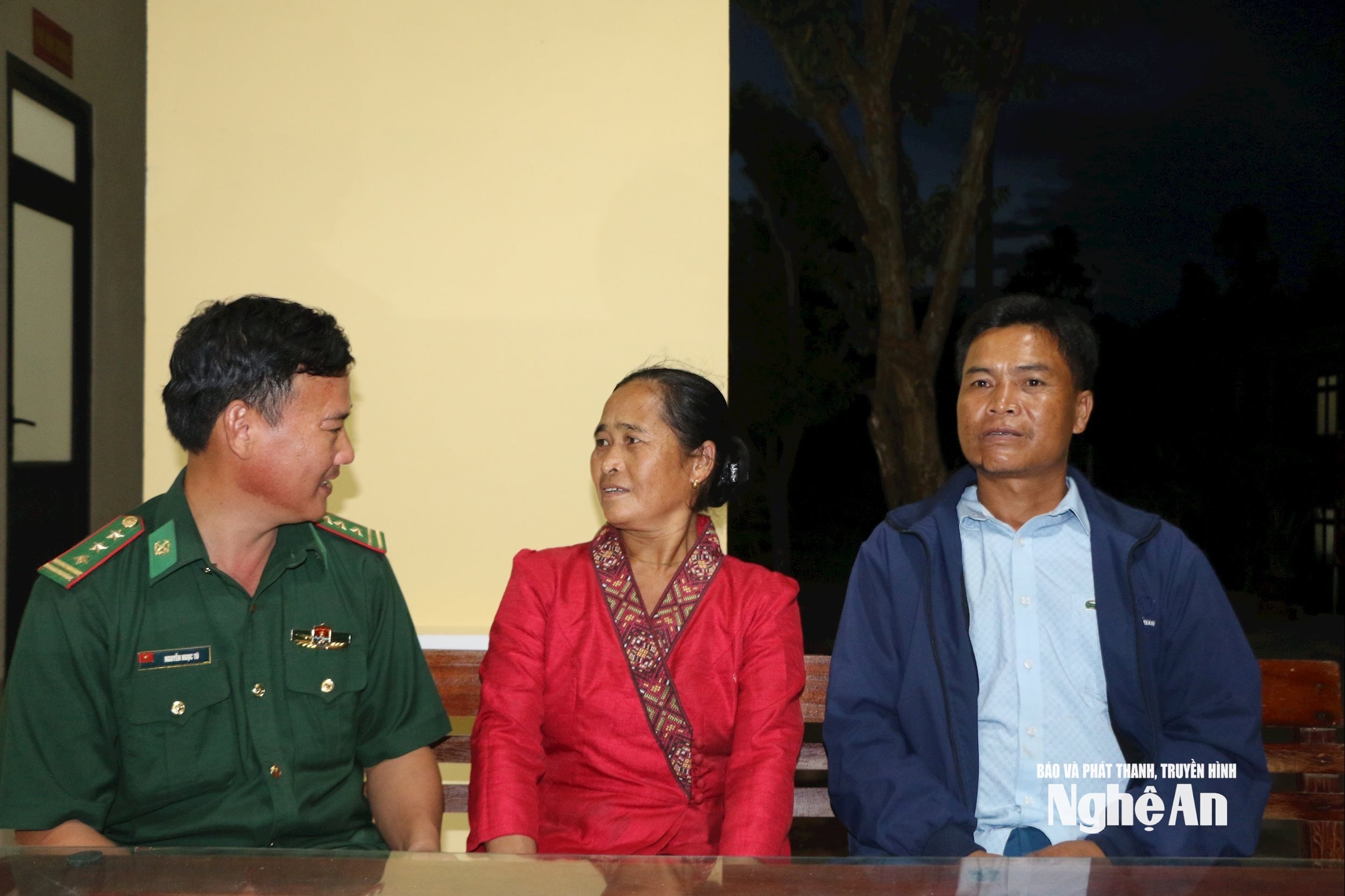 Cặp vợ chồng Việt- Lào Xeo Phò Hoài- Xeo Mẹ Xuôn ở bản Huồi Lê trò chuyện với cán bộ Đồn biên phòng Keng Đu. Ảnh KL