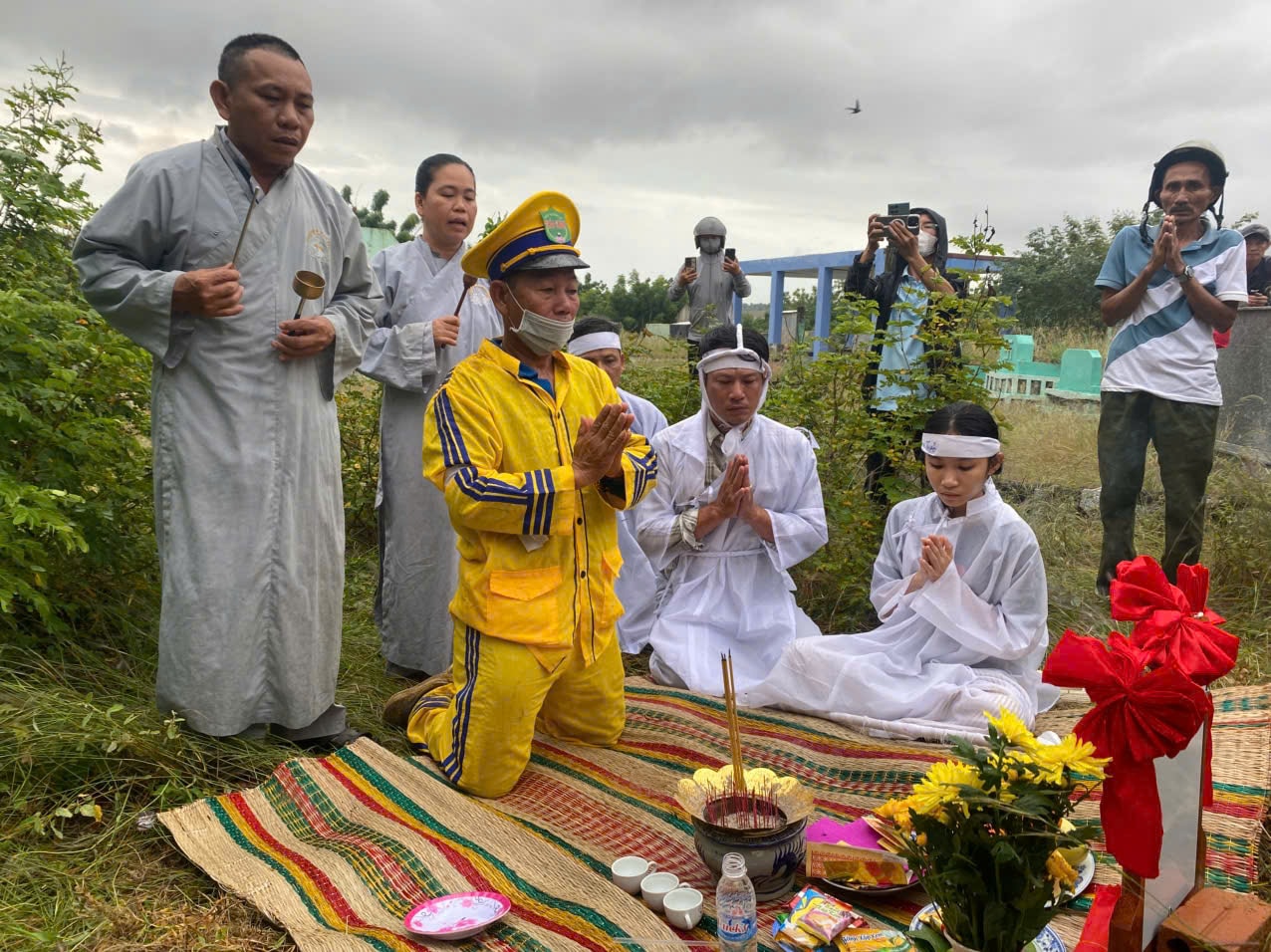 Sư thầy và gia đình tụng kinh cho người quá cố.