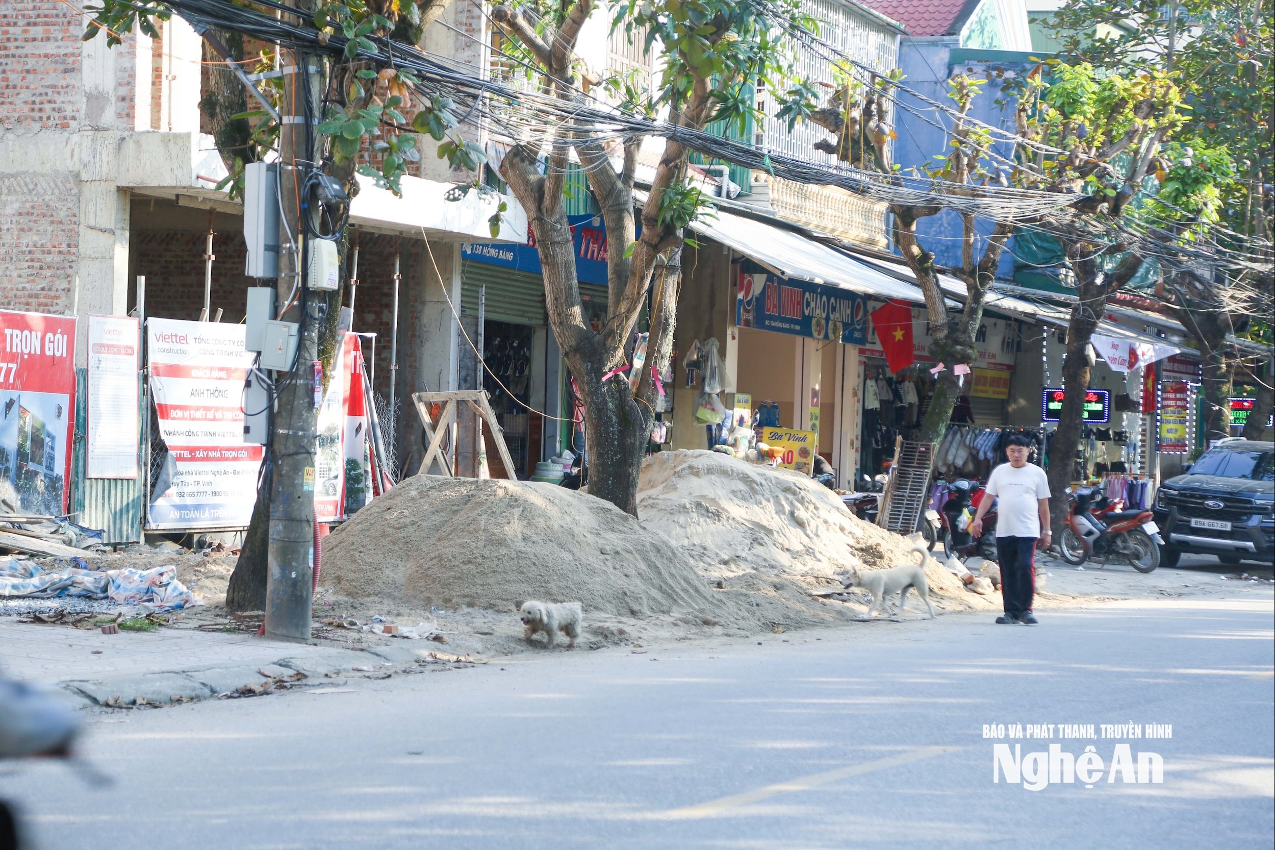 Tại một số nơi, vỉa hè bị chiếm dụng làm nơi tập kết vật liệu xây dựng, buộc người đi bộ phải đi xuống lòng đường, tiềm ẩn nguy hiểm và nguy cơ mất an toàn giao thông. Trong ảnh là hiện trạng tại đường Hồng Bàng, phường Thành Vinh. Ảnh: Đình Tuyên