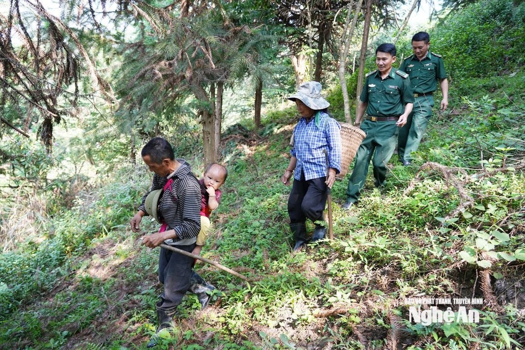 Cán bộ Đồn BP na Ngoi lên thăm khu sản xuất của bà con. Ảnh TP