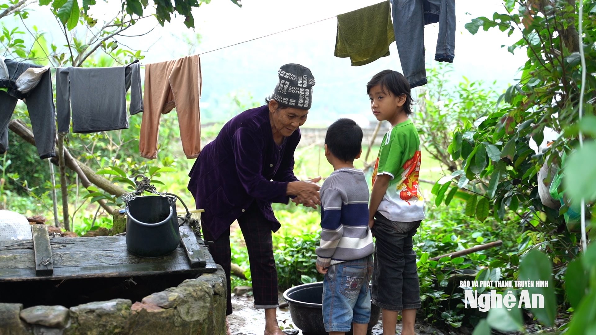 La signora Ngo Thi Tan si prende cura dei nipoti. Foto di Ngoc Dung.