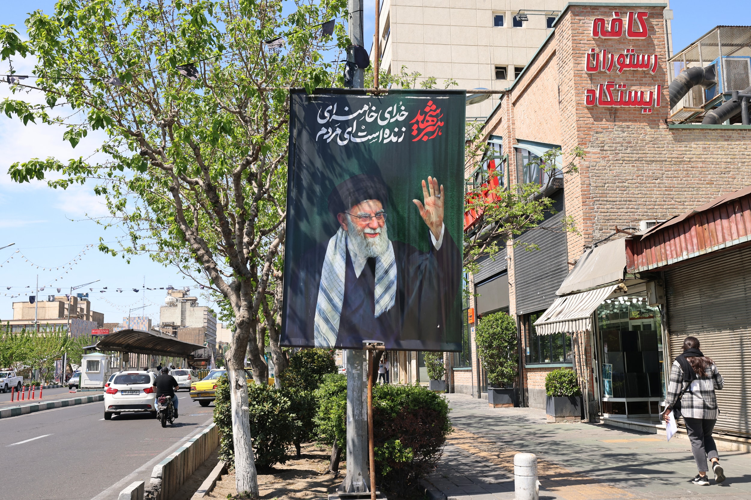 Một phụ nữ đi ngang qua tấm áp phích in hình cố Lãnh tụ tối cao Iran Ayatollah Ali Khamenei trên đường phố Tehran ngày 11/4/2026. Ảnh: AFP