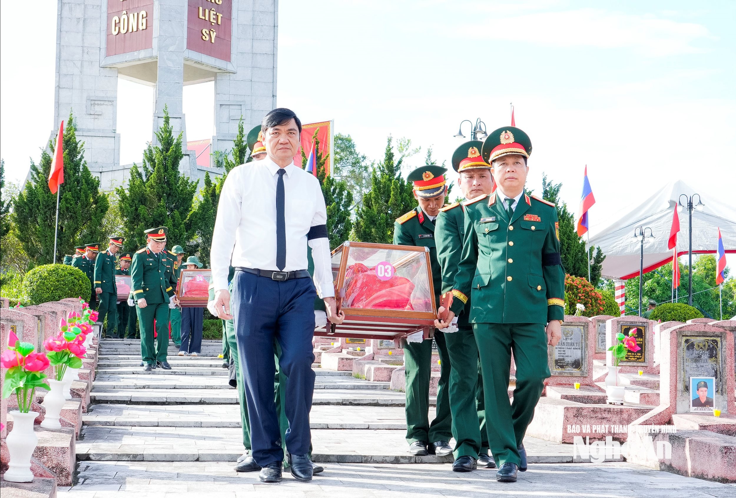 Các đại biểu di chuyển hài cốt liệt sĩ về nơi an nghỉ cuối cùng. Ảnh: Phạm Bằng
