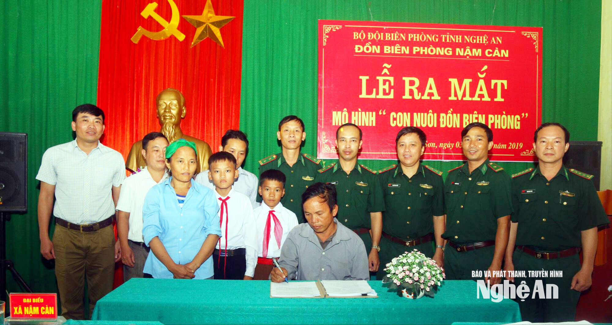 Thà Bá Cha mặc áo trắng đeo khăn quàng đỏ thứ hai phải sang thời điểm ra mắt mô hình con nuôi biên phòng và được Đồn biên phòng Nậm Càn nhận nuôi. Ảnh tư liệu Đào Thọ