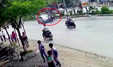 Cụ ông chở cháu qua đường không quan sát, bị ô tô hất văng